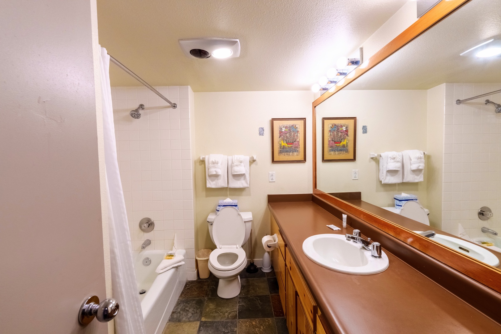 Freshen up in your well-appointed bathroom with a tub-shower combo, generous counter space, and all the essentials laid out for your comfort.