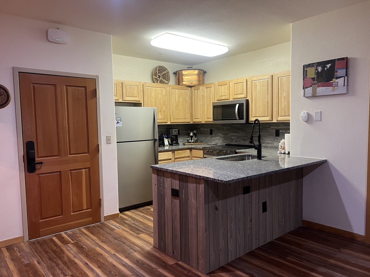 Step into your fully equipped kitchen with stainless steel appliances, granite countertops, and a convenient center island—perfect for preparing meals and gathering with loved ones.