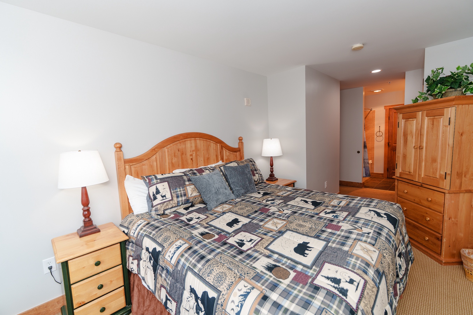 Settle into your cozy bedroom featuring warm wood furnishings, nature-inspired bedding, and thoughtful touches that create the perfect mountain retreat atmosphere.