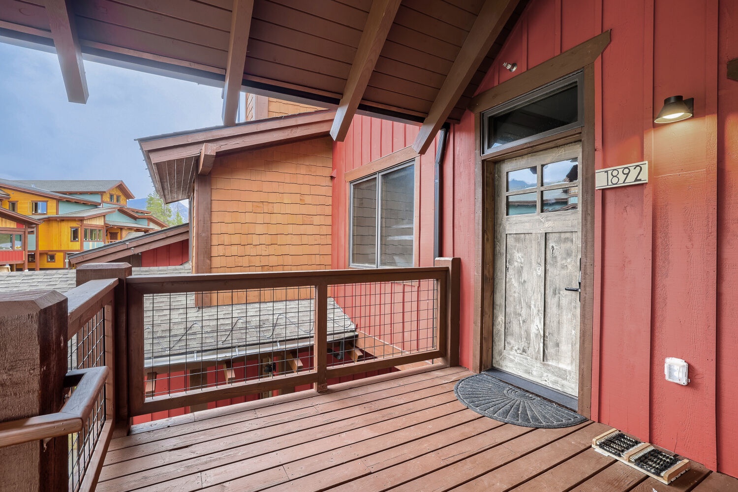 Your home away from home awaits behind this charming rustic door, opening onto a private deck where mountain air and peaceful views greet you each morning.