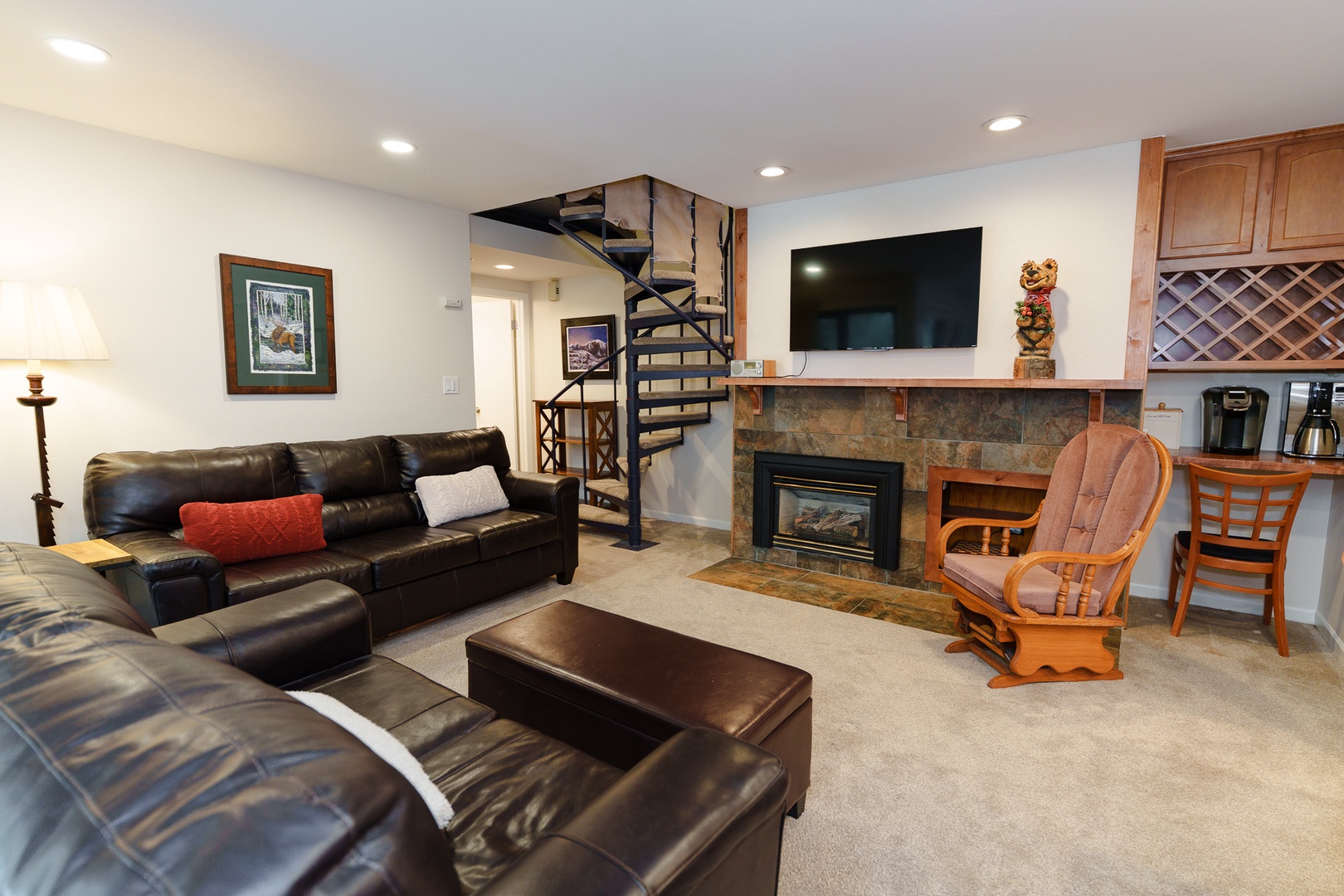 Cozy up in your comfortable living room featuring plush leather seating, a warm fireplace, and modern entertainment center for perfect relaxation.