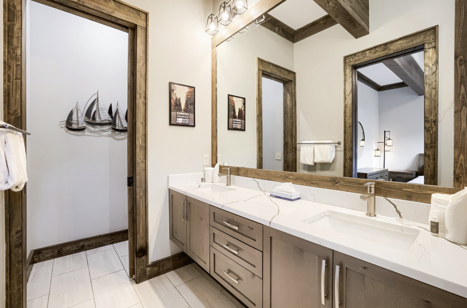 Step into your private sanctuary with dual sinks, warm rustic wood accents, and sleek marble countertops. The modern farmhouse design creates a relaxing retreat where you'll start and end each day in comfort.