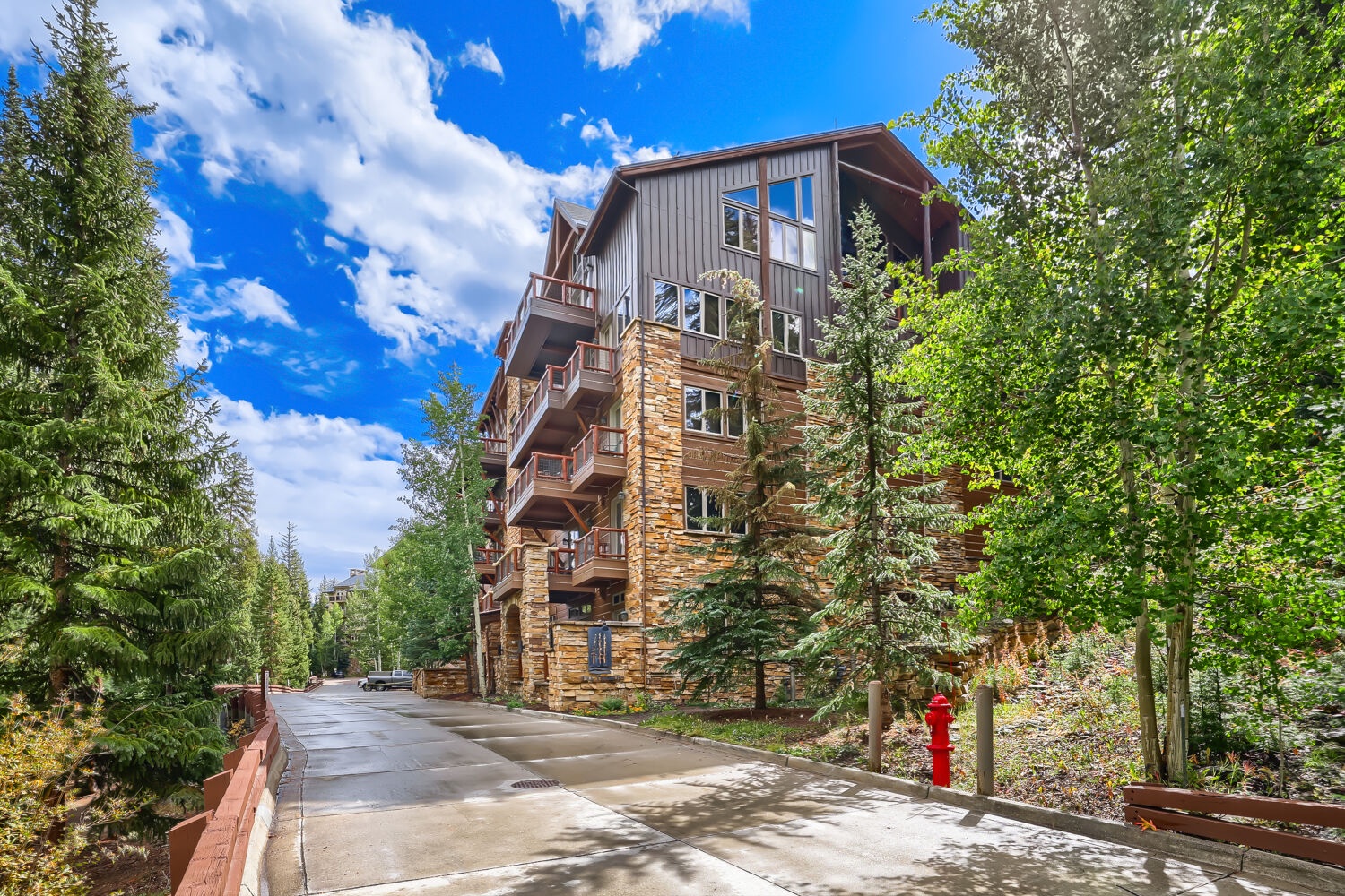 This property is nestled in a peaceful, tree-lined neighborhood with easy access to the building entrance via a quiet street.