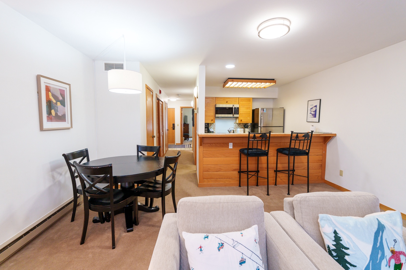 Your open living space flows seamlessly from kitchen to dining, perfect for gathering around the breakfast bar or enjoying meals together.