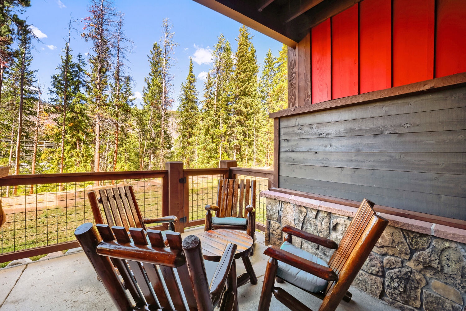 Sip your morning coffee in this serene patio setting, surrounded by towering pines and mountain air. The cozy seating invites you to unwind and soak in the peaceful forest views.