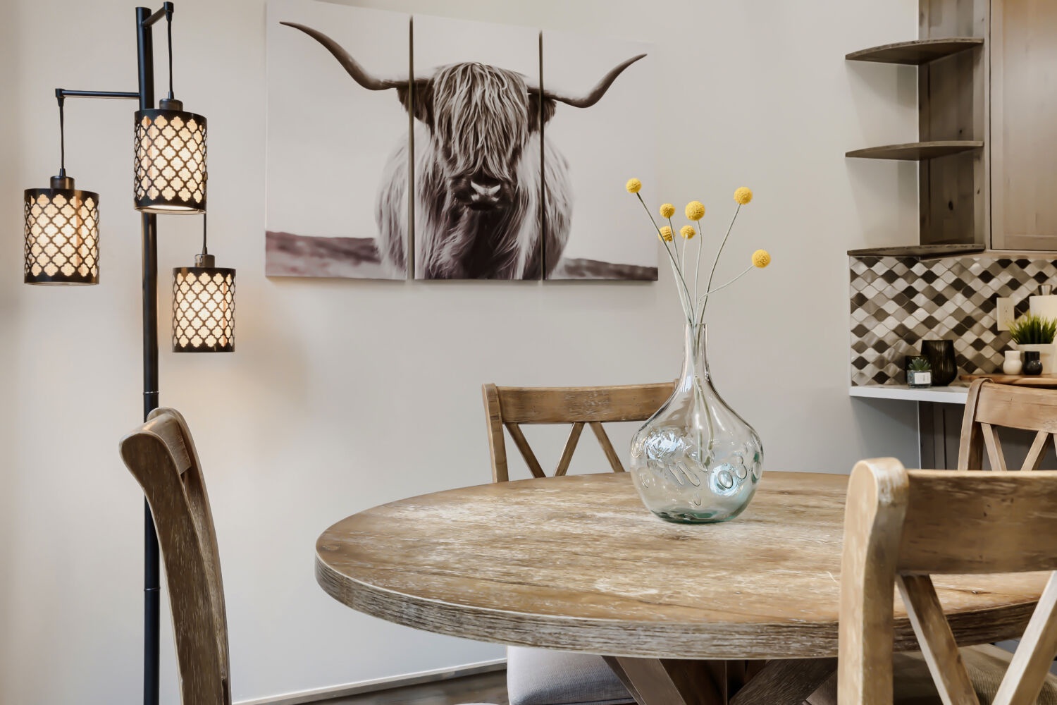 Gather around this inviting dining table, where rustic charm meets modern comfort. Warm pendant lighting and thoughtful décor create the perfect setting for your morning coffee or evening meals together.