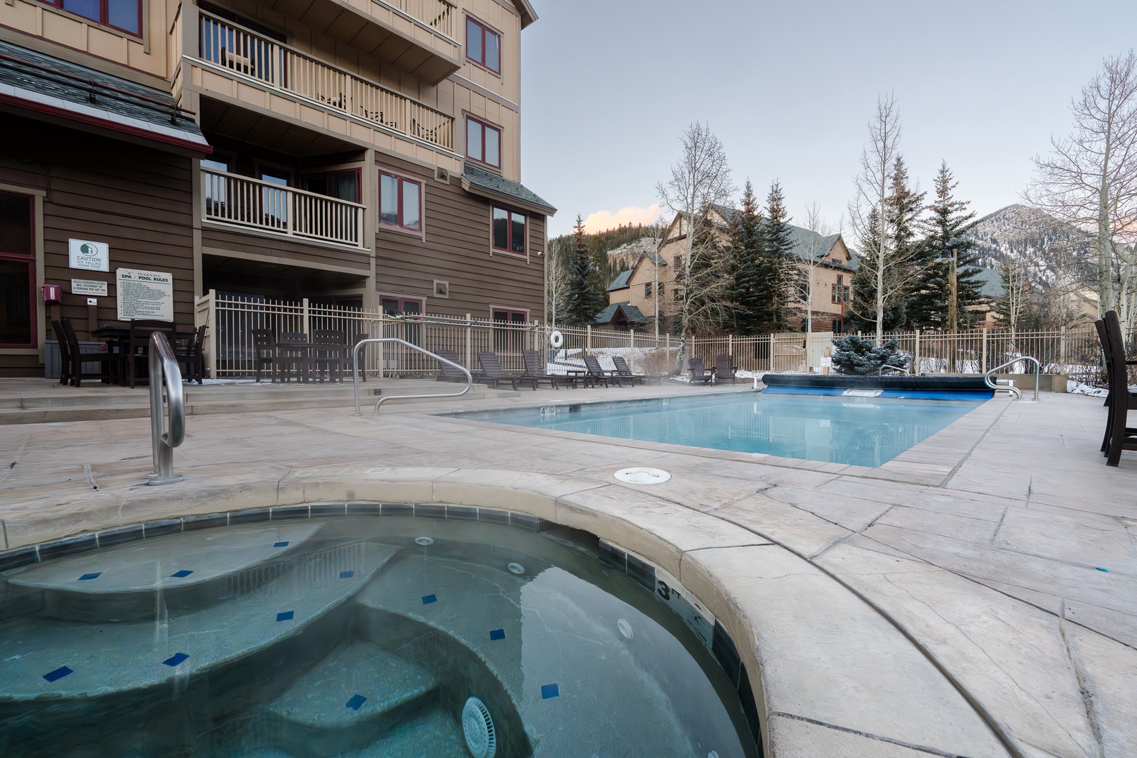 Unwind in the soothing hot tub or take a refreshing dip in the pool while enjoying the serene mountain setting.