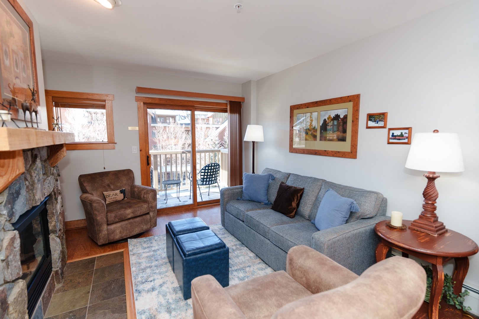 Unwind in your comfortable living room with a cozy fireplace, plush seating, and access to your private balcony for mountain air and views.