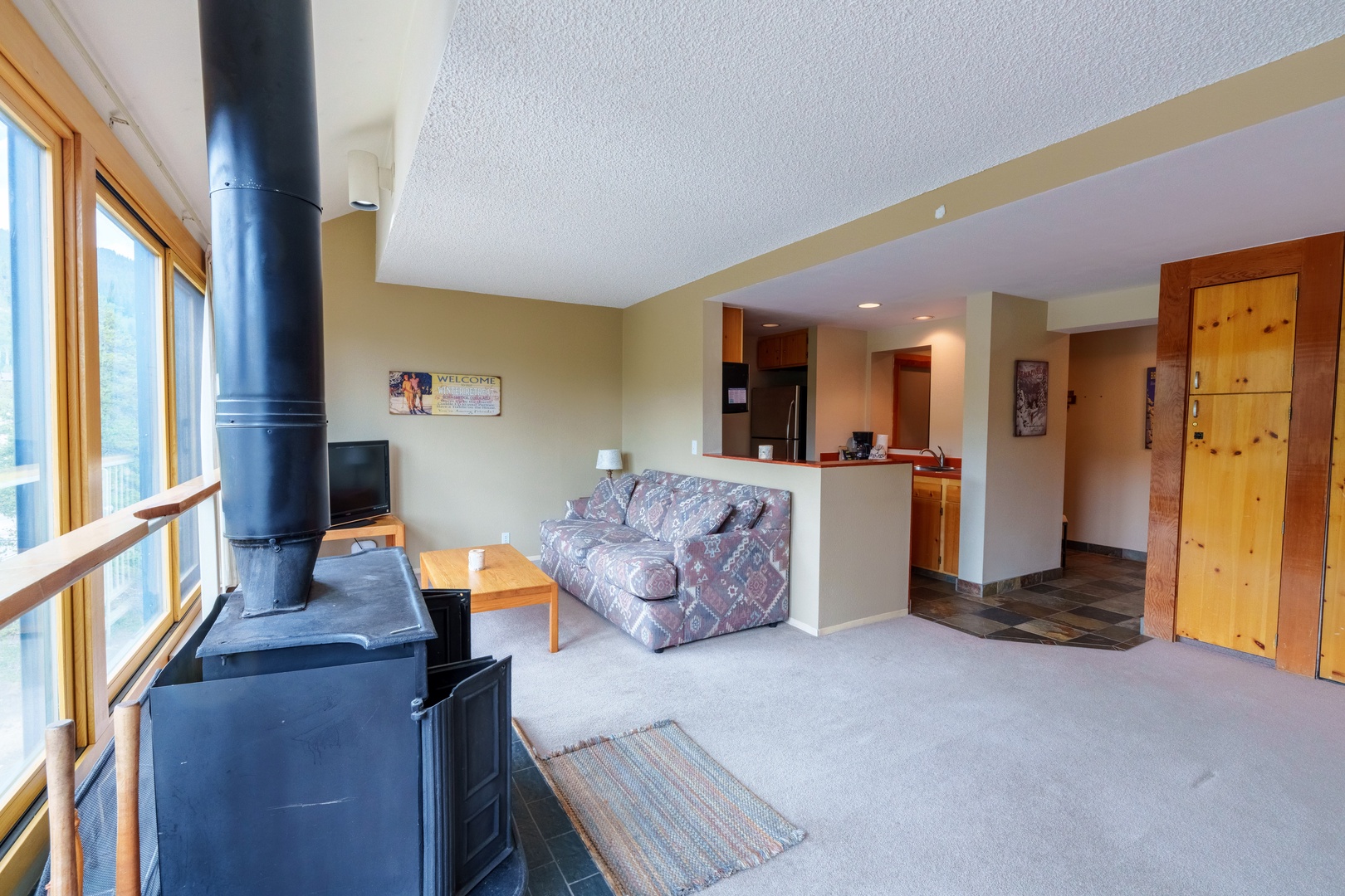 Settle in and feel the warmth of your own cozy fireplace as natural light streams through wide windows, creating a welcoming retreat where you can truly unwind.