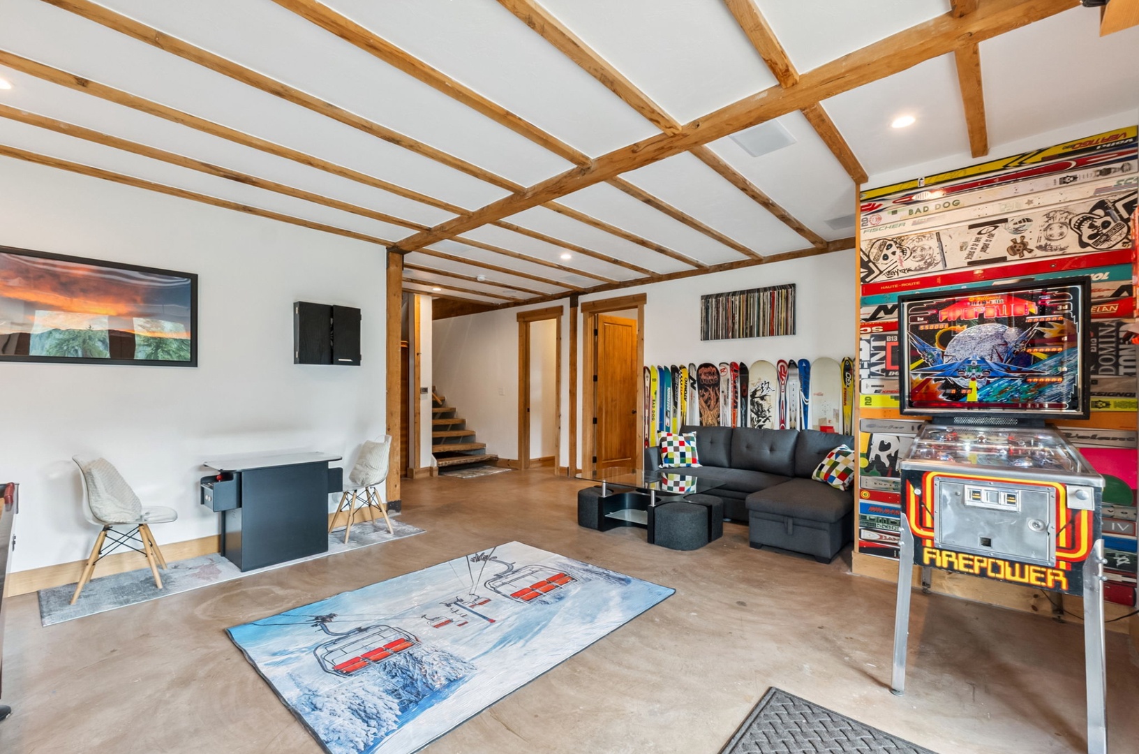 Your private game room awaits with exposed wood beams, a classic pinball machine, and vibrant retro décor. Unwind on the sectional sofa or challenge friends to a round at the arcade table.