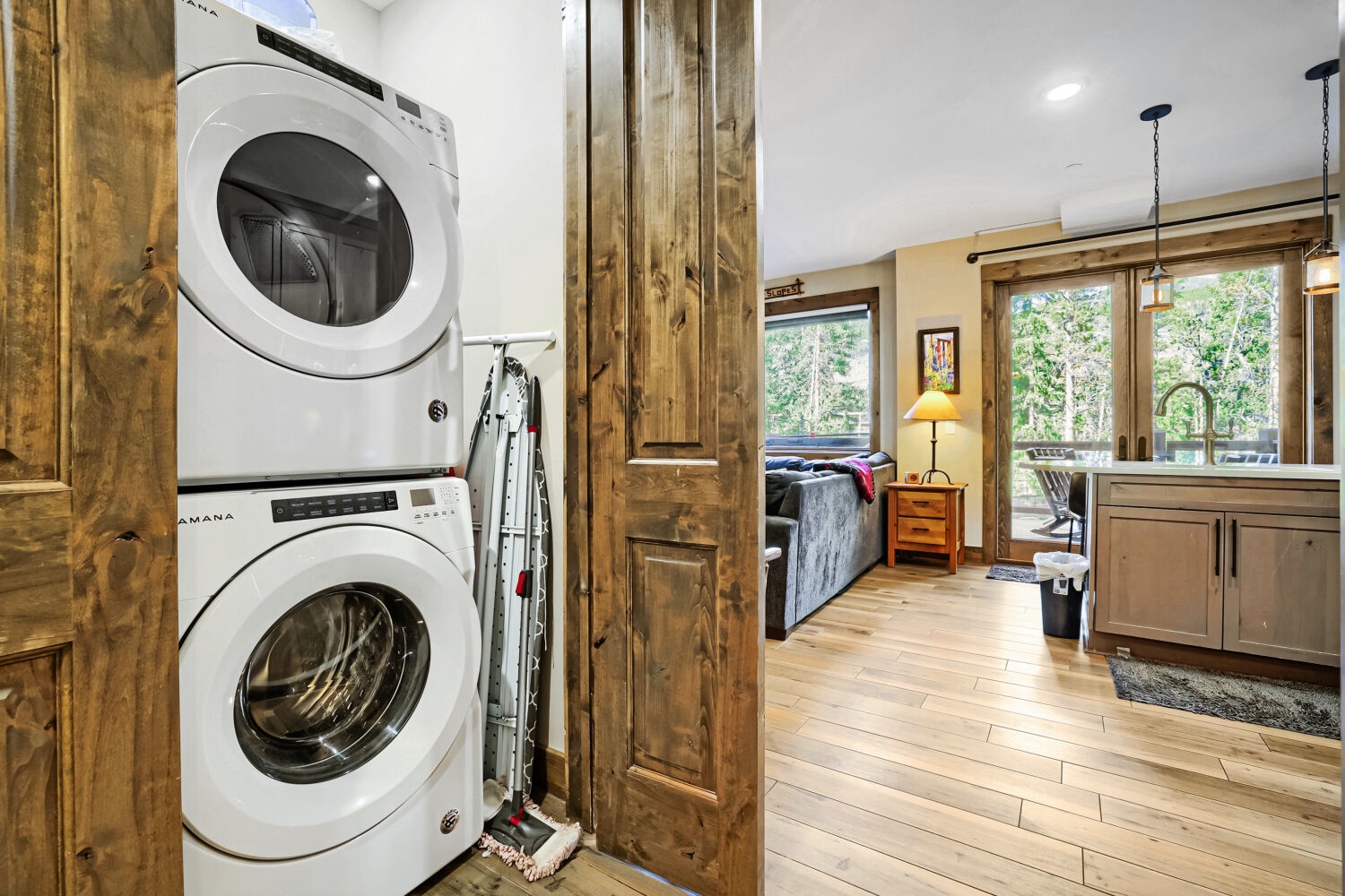 Stay fresh with your own in-unit washer and dryer, tucked neatly beside rustic wood finishes that add warmth and character to your mountain escape.