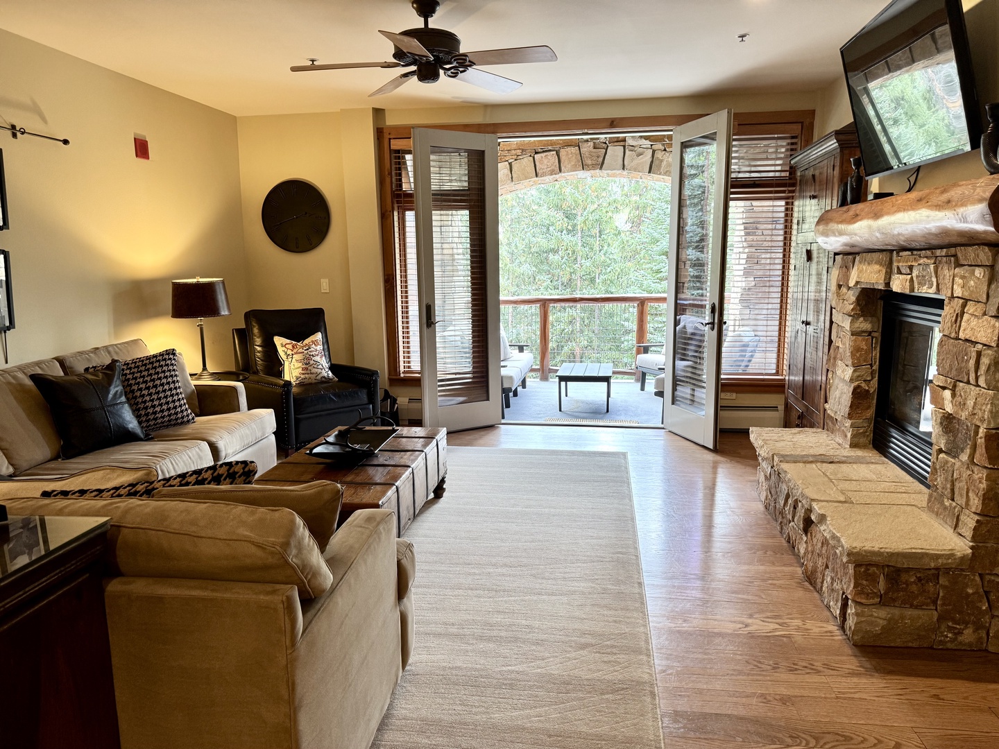 Sink into plush seating by the stone fireplace, then step out to your private balcony for a breath of fresh air—your perfect blend of cozy indoors and serene mountain views.