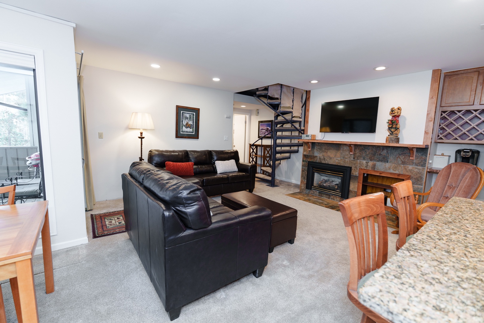 Relax in your spacious living area with plush leather seating, cozy fireplace, and modern entertainment center - perfect for unwinding after your adventures.