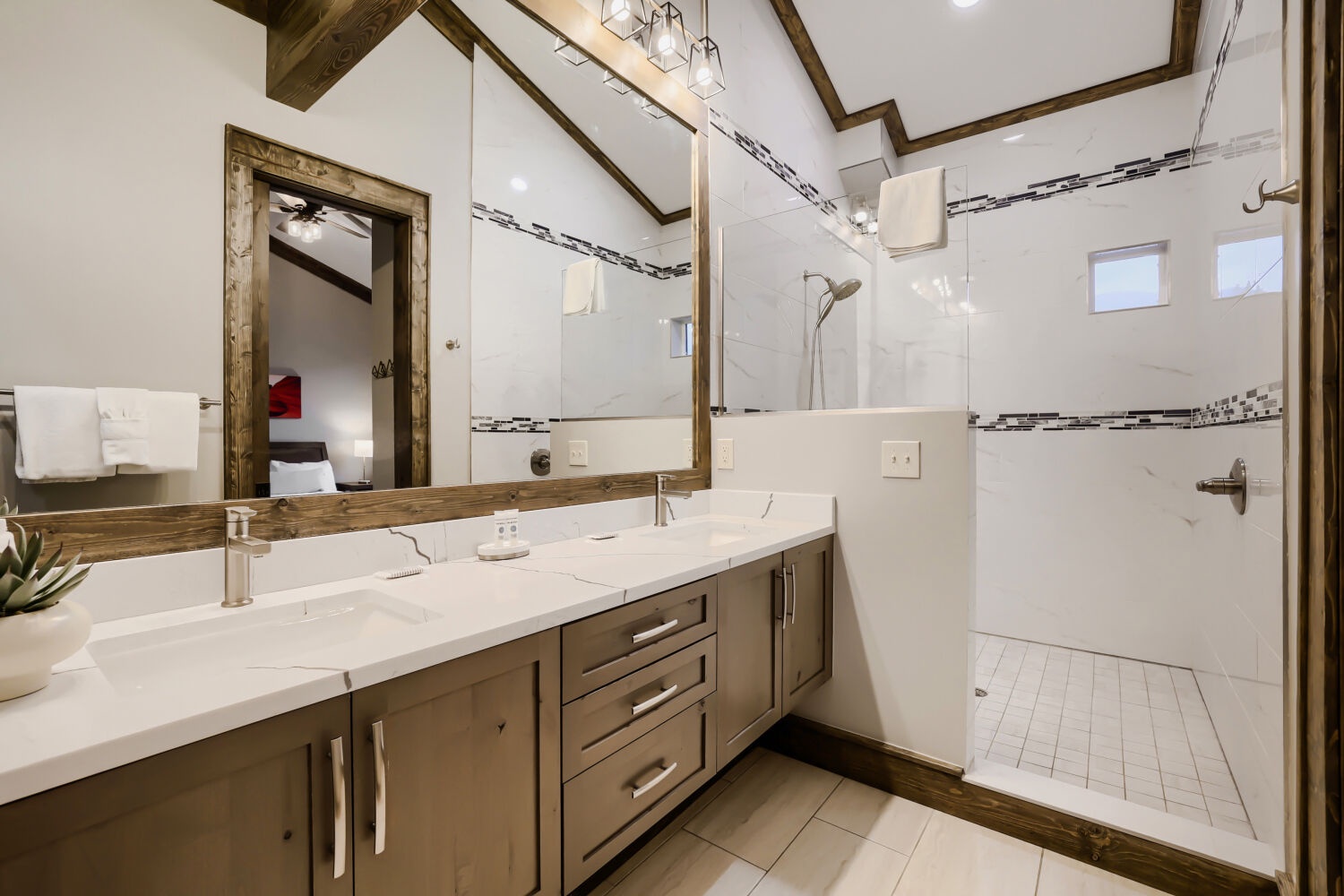 Step into your spa-like retreat with double vanity sinks, elegant countertops, and a spacious walk-in shower—your morning refresh starts here.