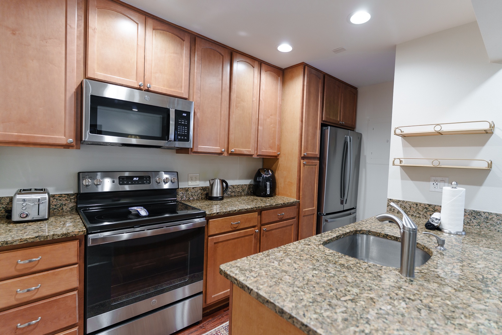 Your fully equipped kitchen features granite countertops, stainless steel appliances, and ample cabinet space for preparing meals during your stay.