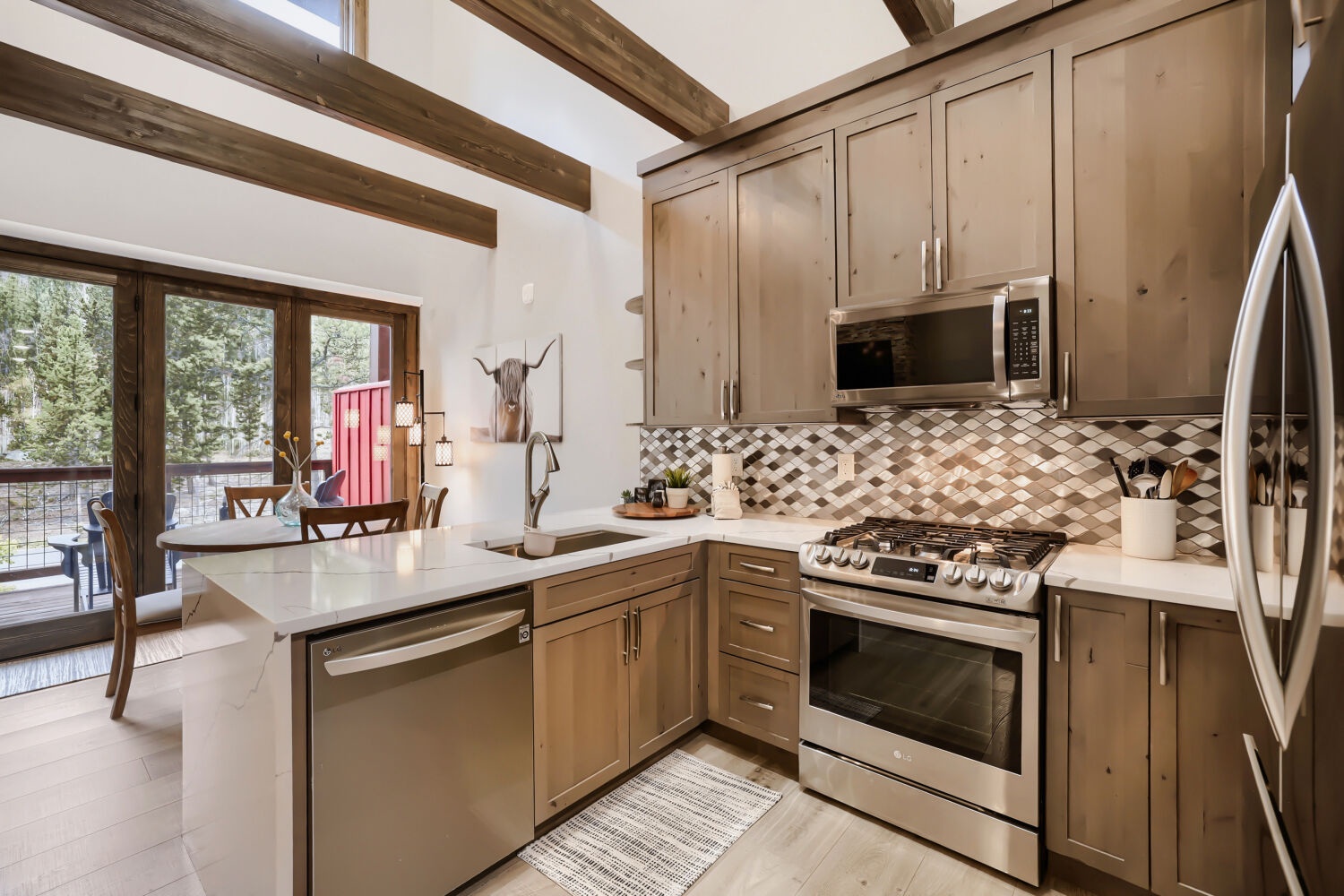 Your fully equipped kitchen features modern appliances, elegant cabinetry, and a bright open layout that invites you to prepare meals in mountain-chic comfort.