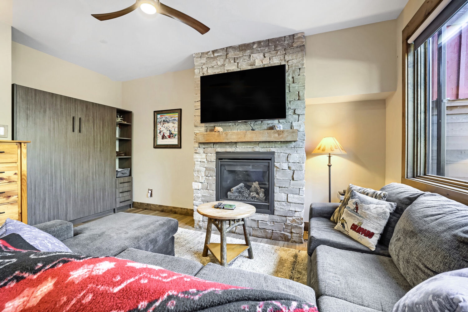 Curl up on plush sofas by a crackling stone fireplace—your cozy haven after a day exploring the mountains. A soft glow and rustic warmth make every evening feel like a retreat.