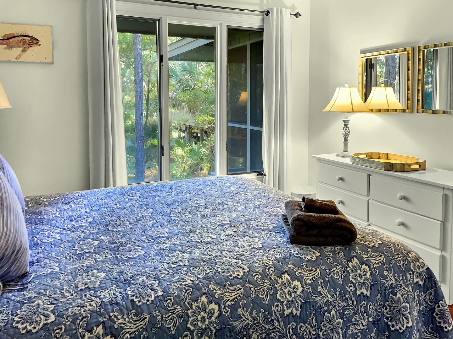 Wake up to tropical garden views through your private sliding doors, then unwind in this serene bedroom with elegant furnishings and soft lighting.