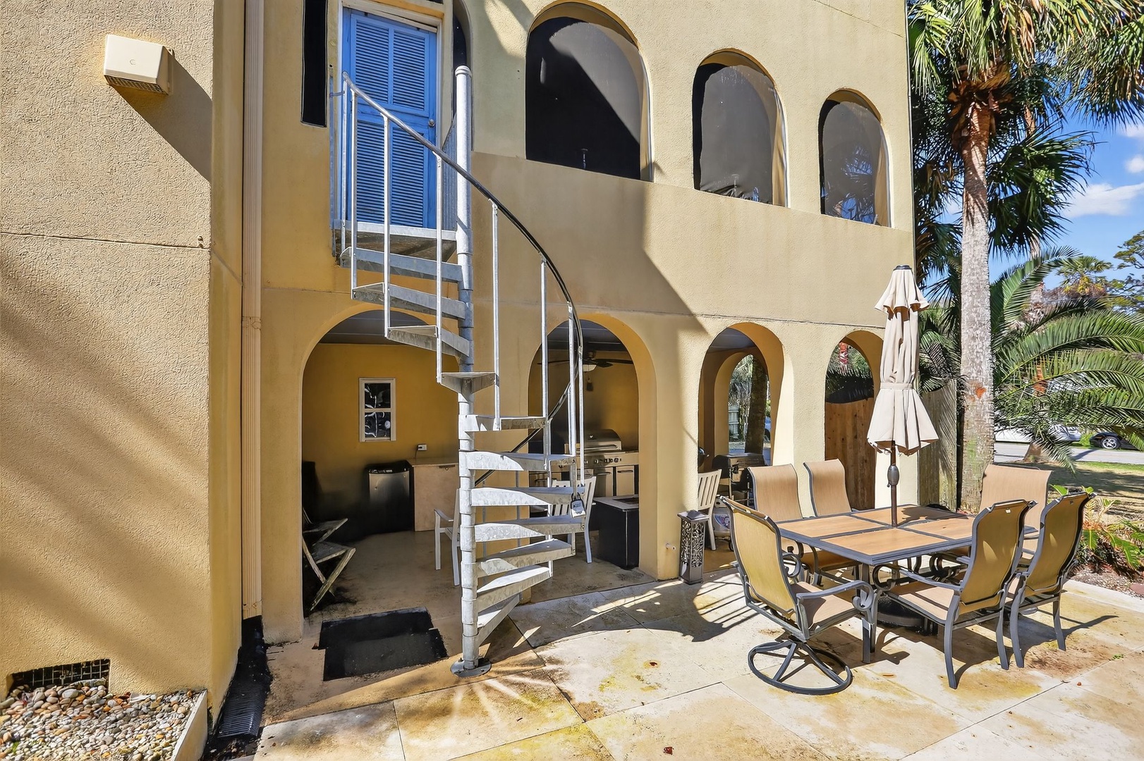 Outdoor Patio – Seating Area with Winding Staircase to Upper Enclosed Porch