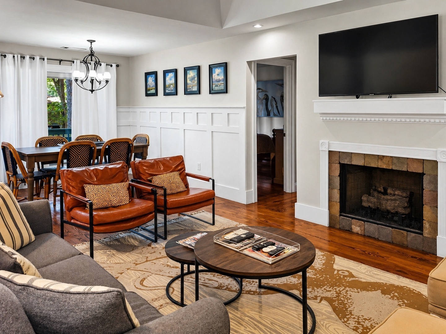 Sink into plush leather chairs by your fireplace, where warm hardwood floors and elegant details create the perfect gathering space.