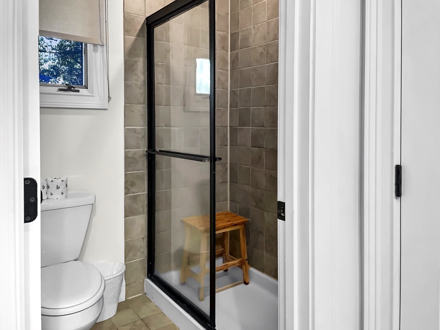 Step into your private bathroom sanctuary with modern glass shower, natural light, and thoughtful amenities for your comfort.