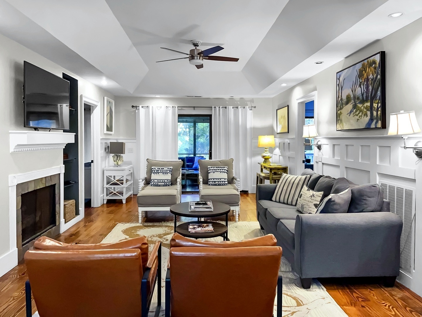 Unwind in your sophisticated living room with cozy fireplace, plush seating, and elegant coffered ceiling details.