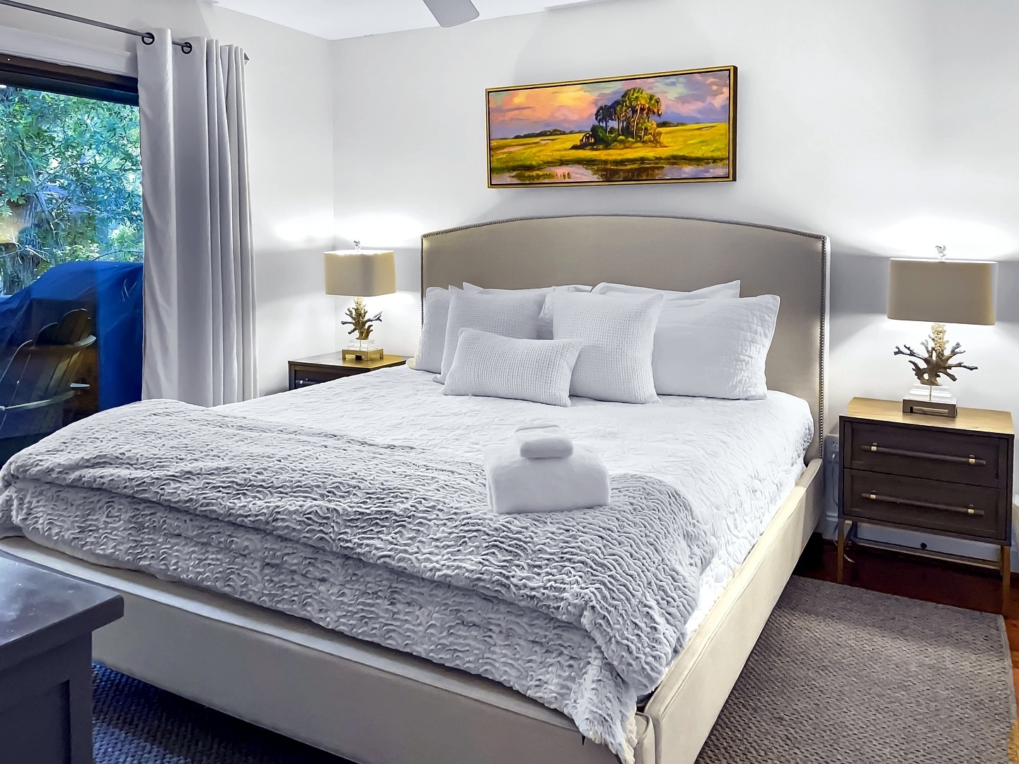 Drift off in this serene bedroom where plush linens and peaceful garden views create your perfect retreat.