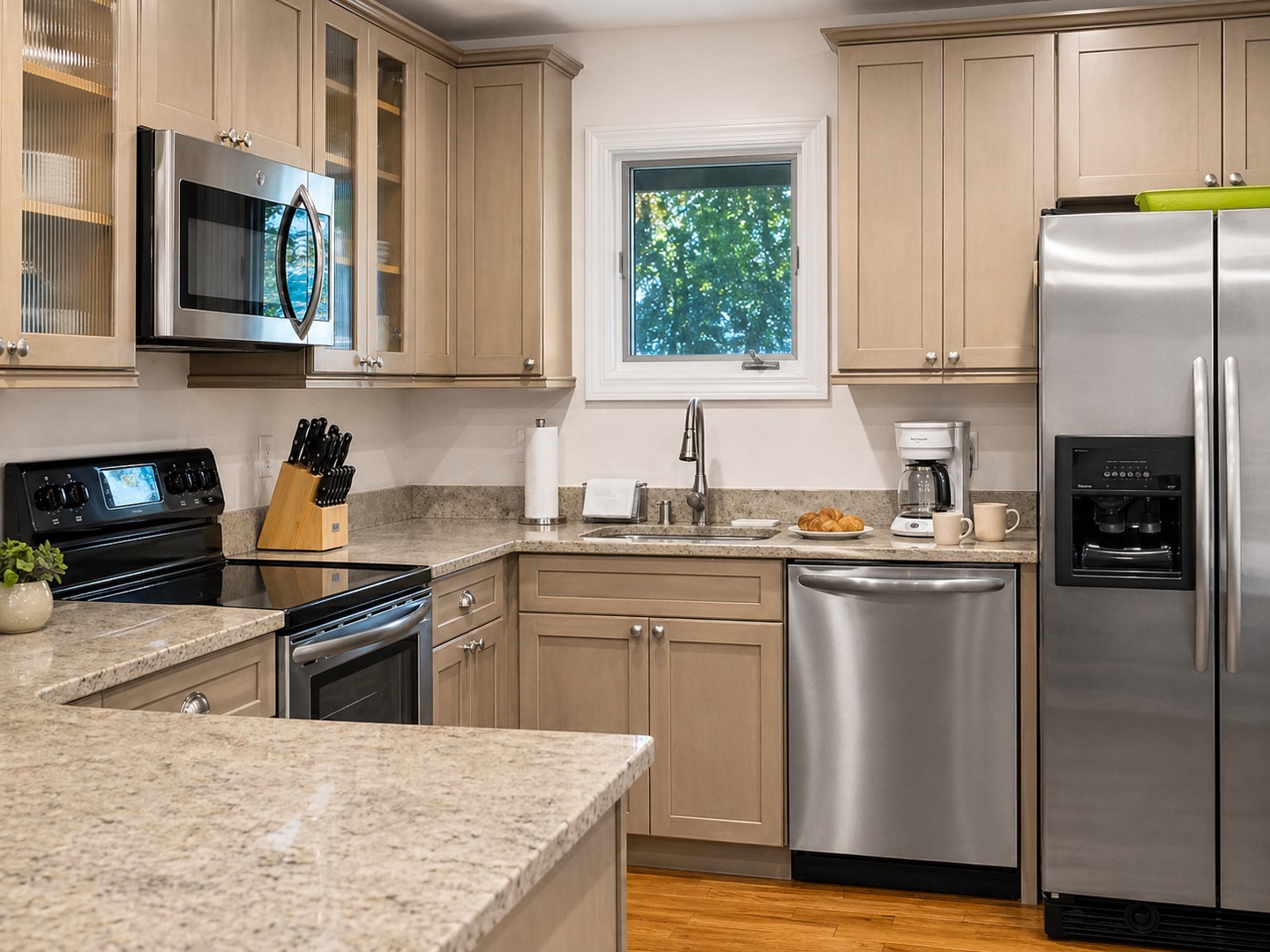 You'll love preparing meals in this fully equipped kitchen with stainless steel appliances, granite countertops, and natural light.