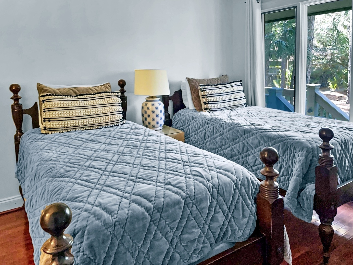 Rest peacefully in your twin beds with soft quilted bedding and lush garden views streaming through your private balcony doors.