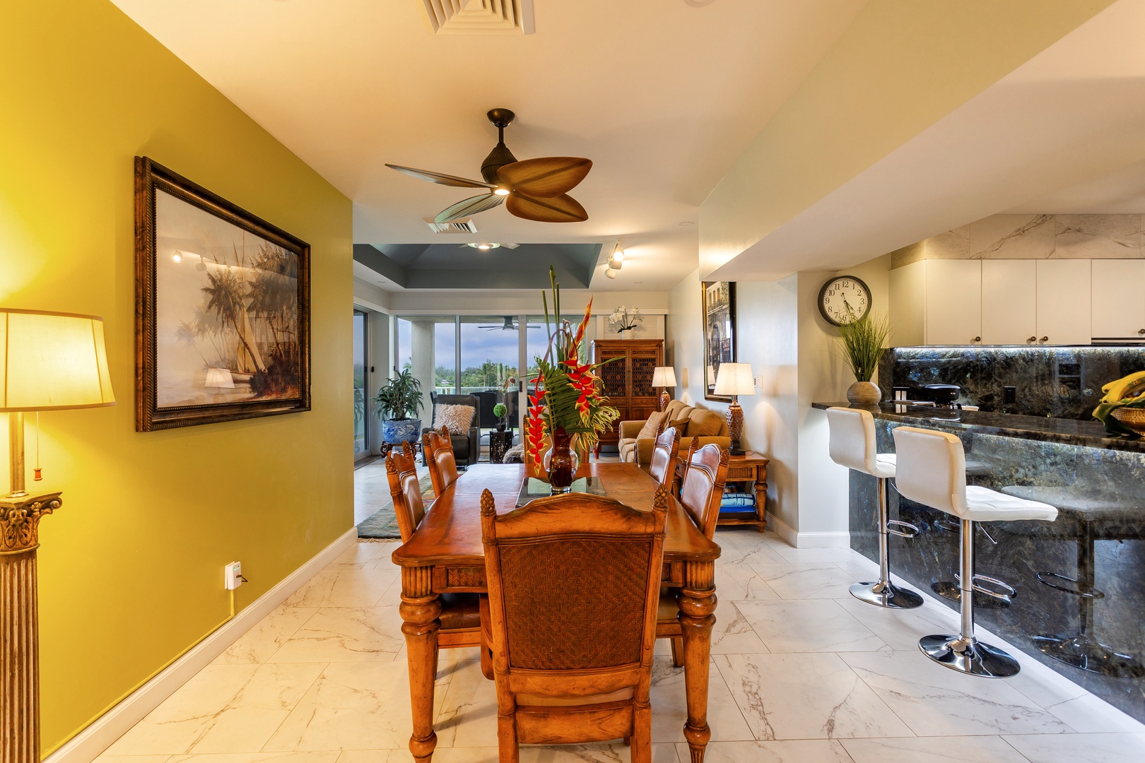 Gather around the handsome wood dining table where your vacation meals become memorable moments. Vibrant décor and tropical touches set a warm, inviting tone for togetherness.