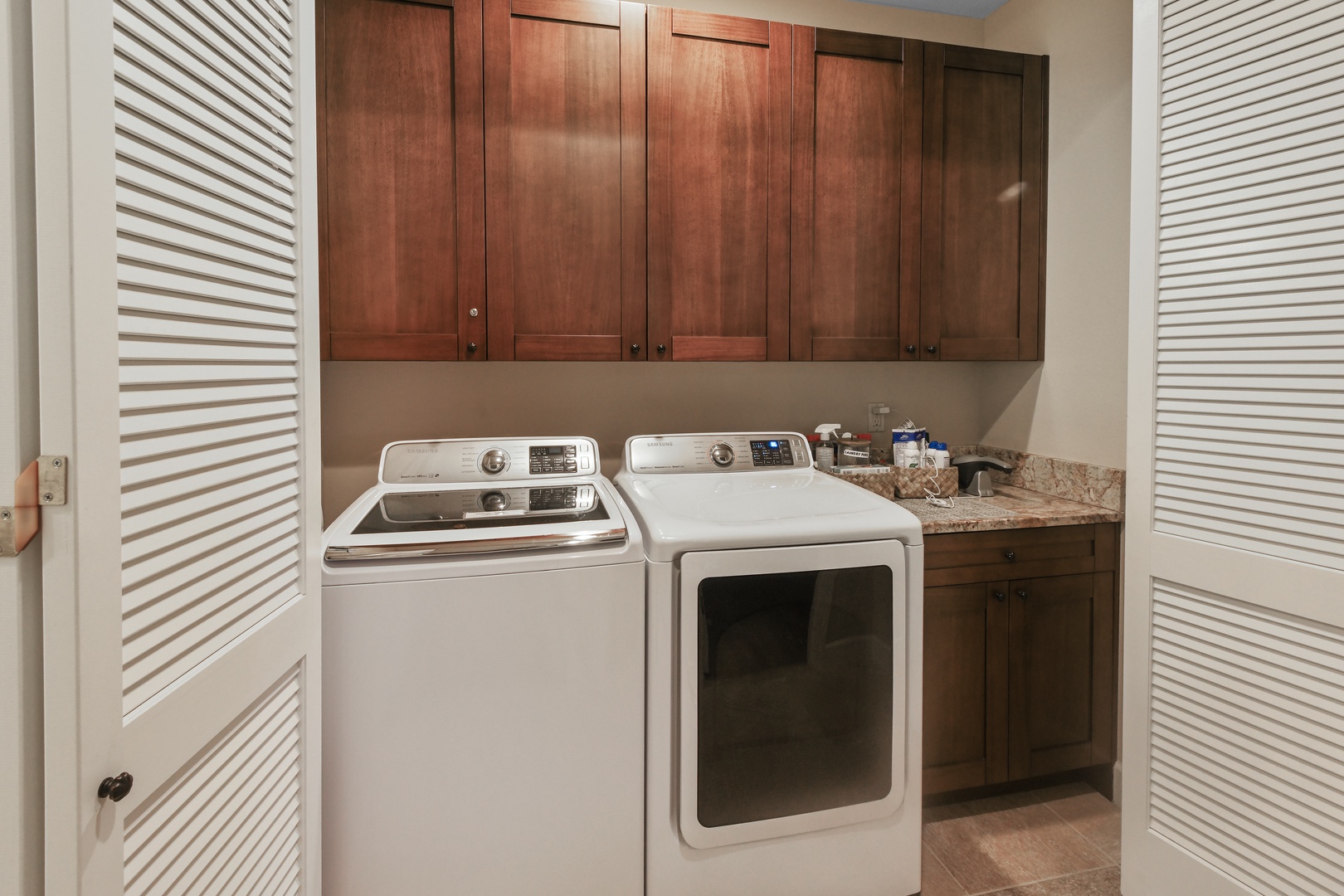 Your dedicated laundry room features full-size appliances and rich wood cabinetry, making wash day feel effortless and organized.