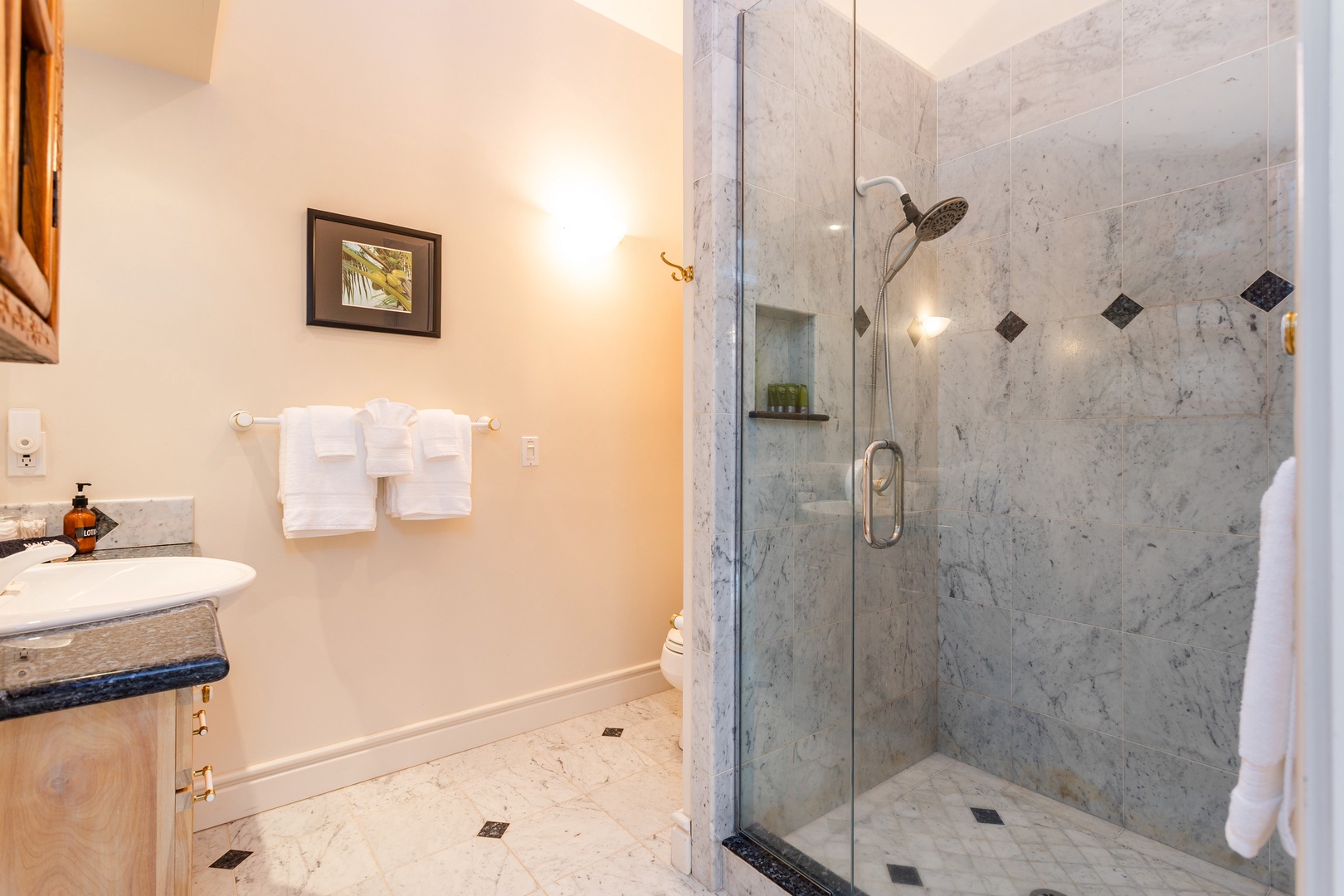 Ohana (Guest House) - Sink into luxury in your private marble bathroom featuring a spacious walk-in shower with premium fixtures and plush towels awaiting your arrival.