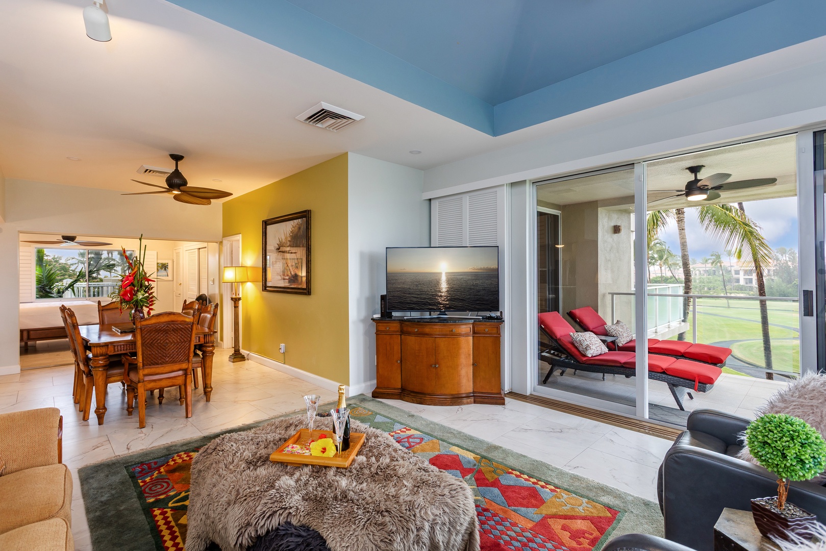 Step into your coastal retreat with vibrant colors, cozy seating, and seamless access to your private balcony where tropical views await. Relax with entertainment inside or unwind outdoors on plush lounge chairs.