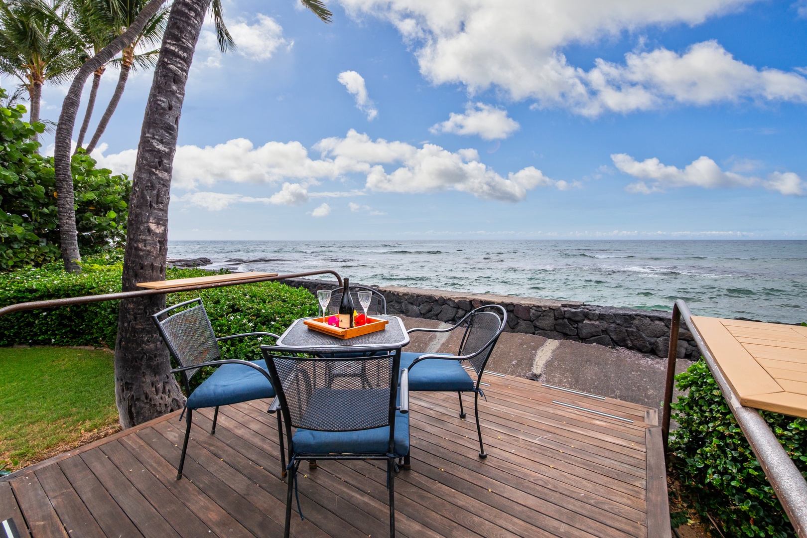 Sip morning coffee at your private oceanfront deck, where tropical palms frame endless sea views and gentle waves create the perfect backdrop for relaxation.