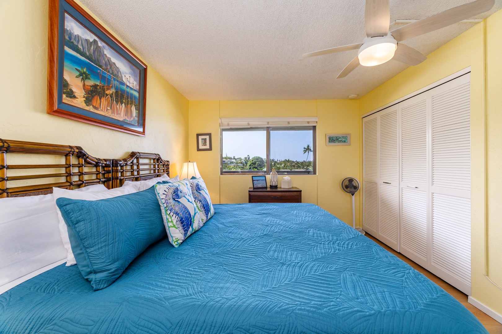 Wake up to island sunshine in this cheerful bedroom with vibrant tropical colors, a comfortable bed, and a palm tree view that brings paradise right to your window.