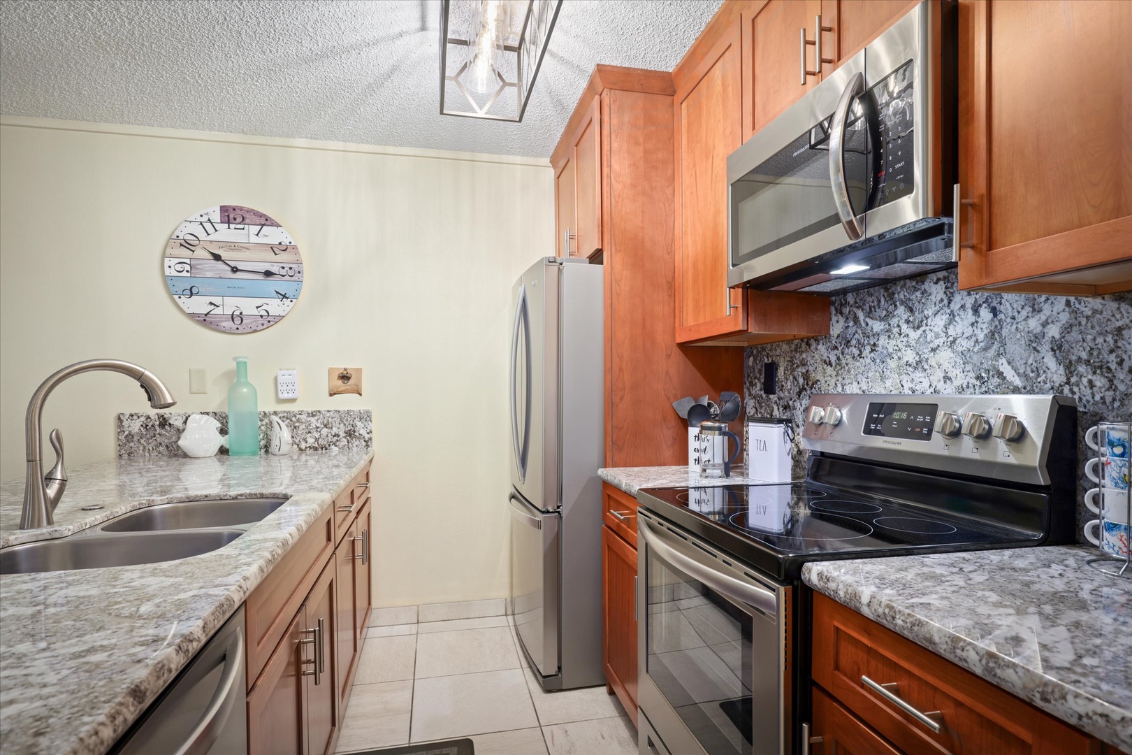 Picture yourself cooking up your favorite meal in this bright, fully-equipped kitchen. Gleaming granite countertops, rich wood cabinetry, and stainless steel appliances make your vacation prep feel effortless and welcoming.
