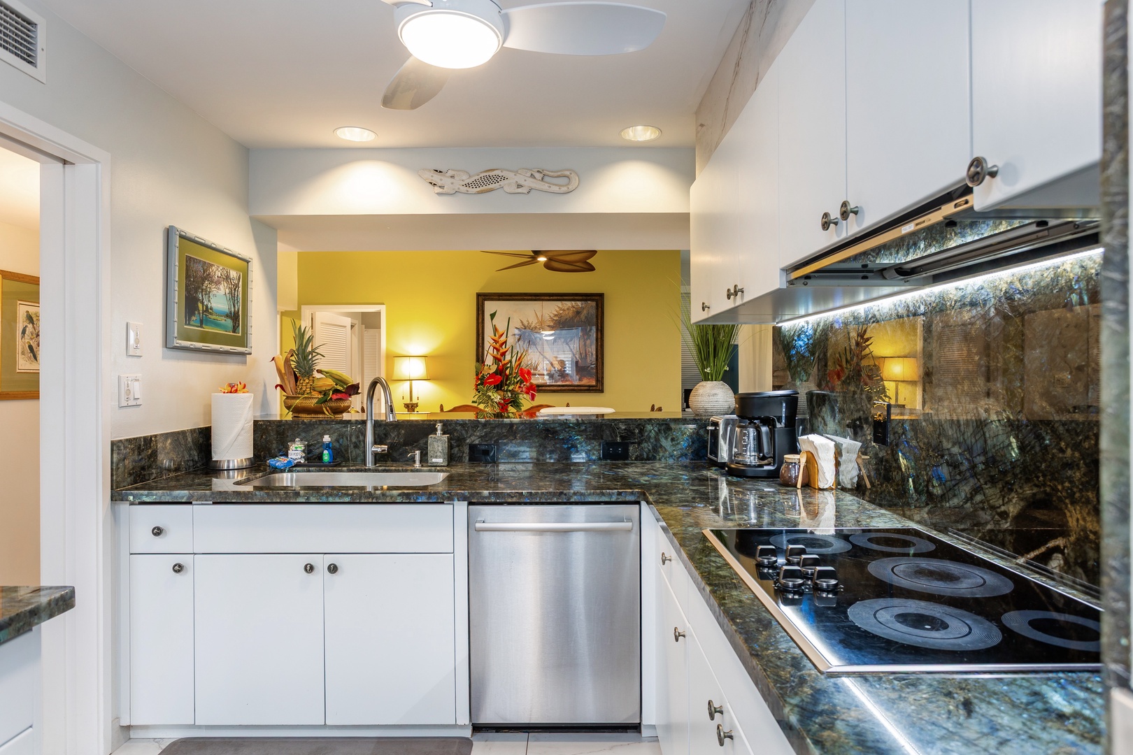 Cook meals with ease in your fully equipped kitchen, featuring elegant granite counters, modern appliances, and charming tropical décor that makes you feel right at home.