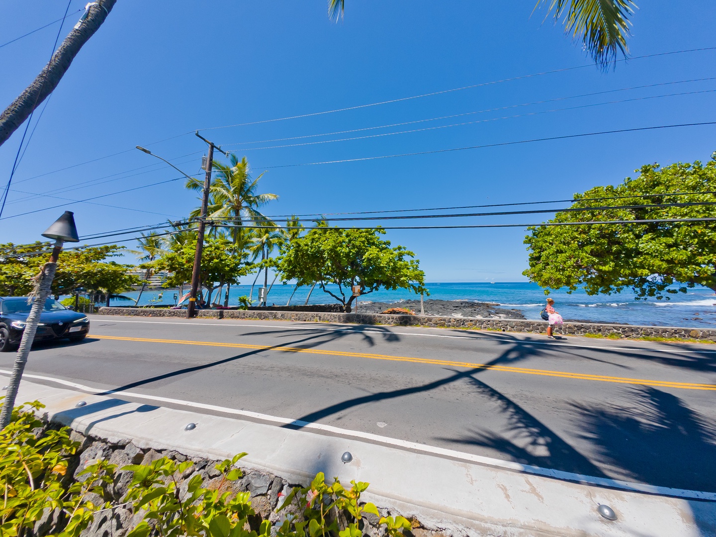 Beachfront coastal property situated along scenic oceanside road with lush tropical landscaping, turquoise waters, and convenient access to local attractions and shoreline activities.