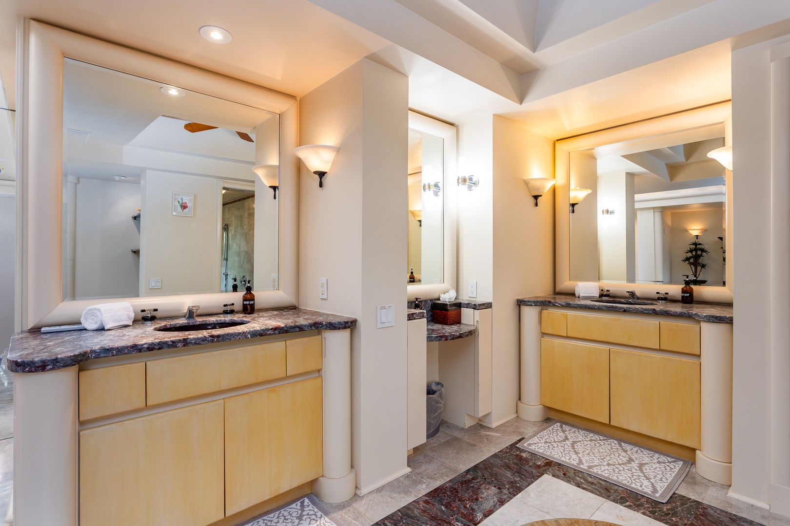 Primary Bathroom - Twin vanities with sleek granite countertops and warm lighting create your private spa-like retreat, where every morning begins in luxury and style.