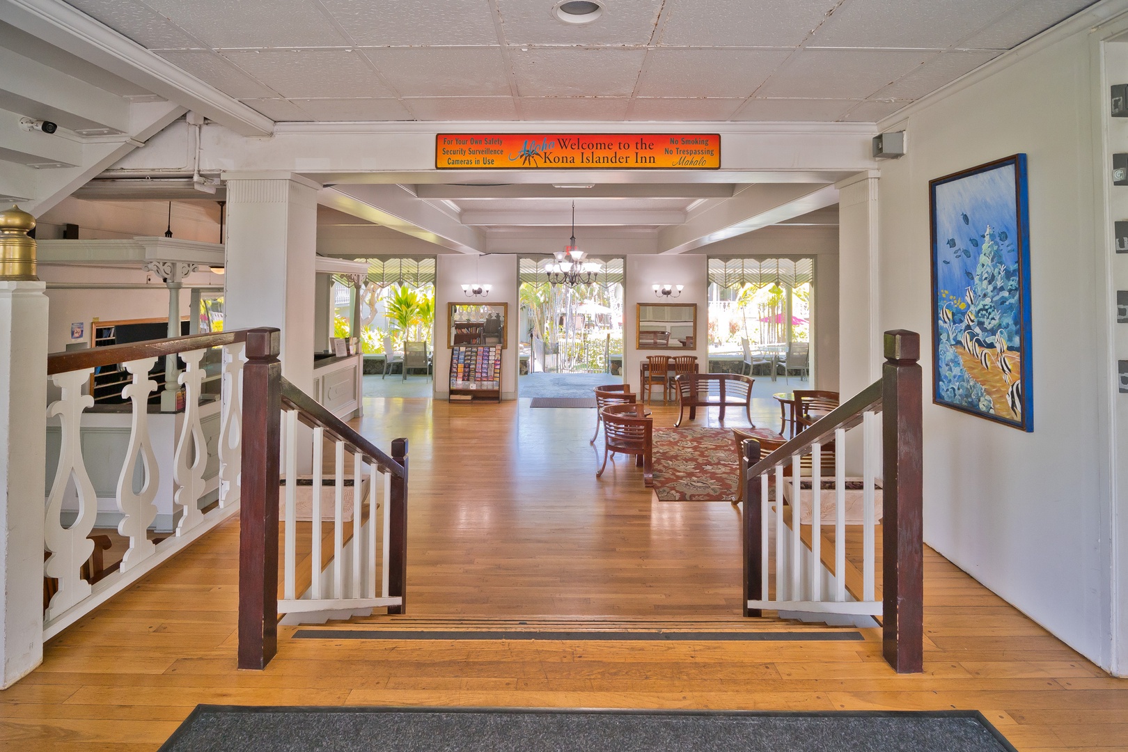 The Kona Islander Inn welcomes guests with its open, inviting Hawaiian-style lobby featuring tropical charm, warm wood accents, and vibrant island artwork setting the tone for your stay.