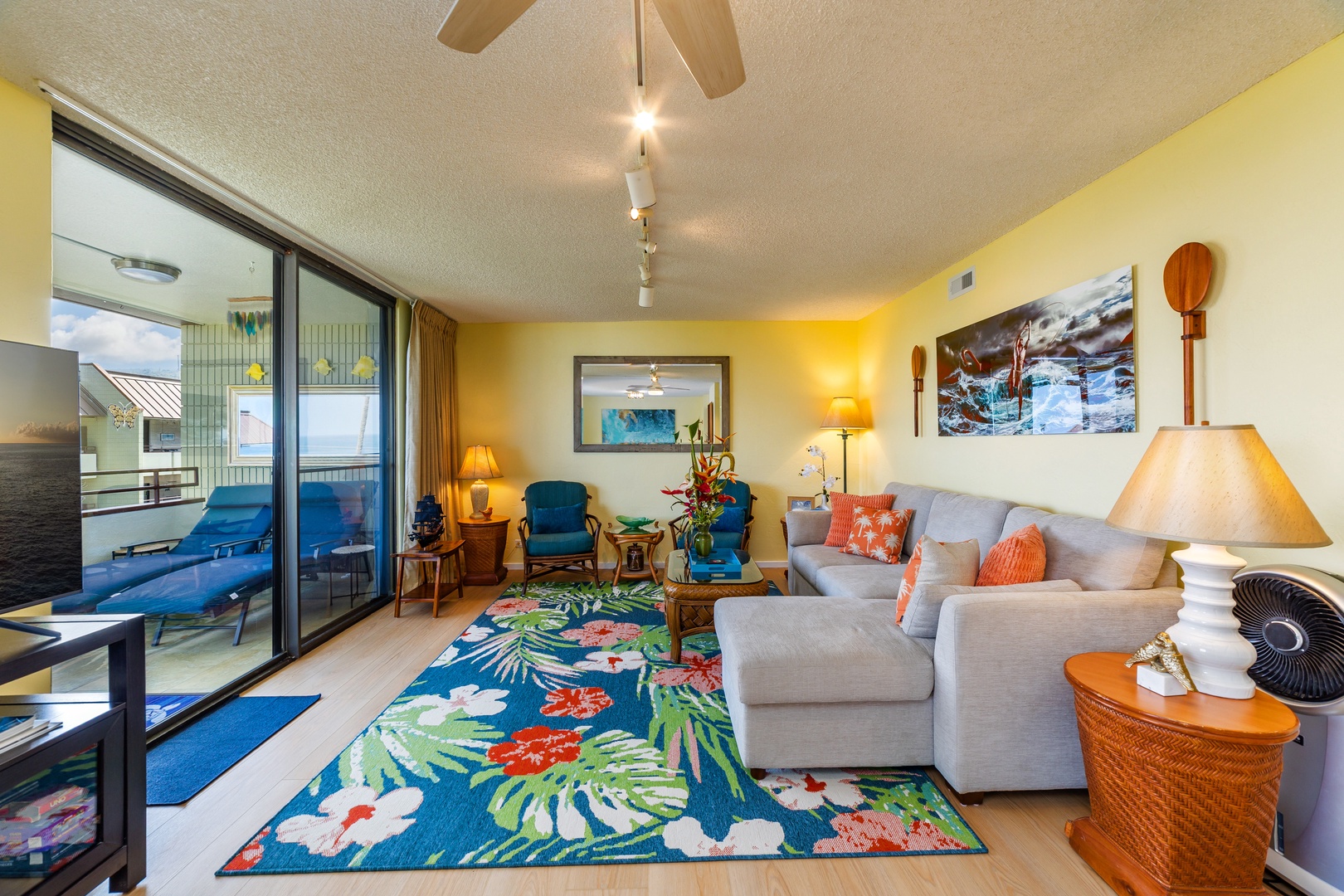 Sink into the plush sectional and feel coastal breezes drift through, as vibrant tropical colors and beachside decor set the tone for your laid-back island escape.