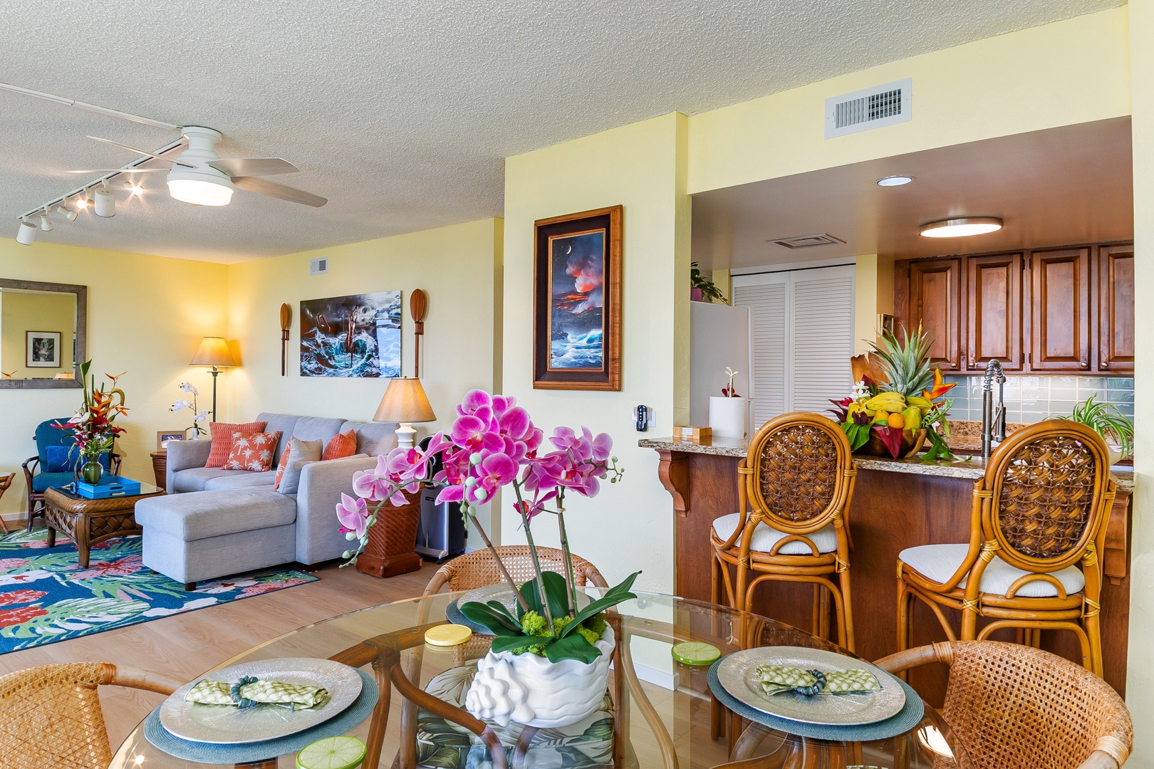 Step into your tropical retreat, where bright orchids and island-inspired décor welcome you to an open living and dining space perfect for gathering with loved ones.