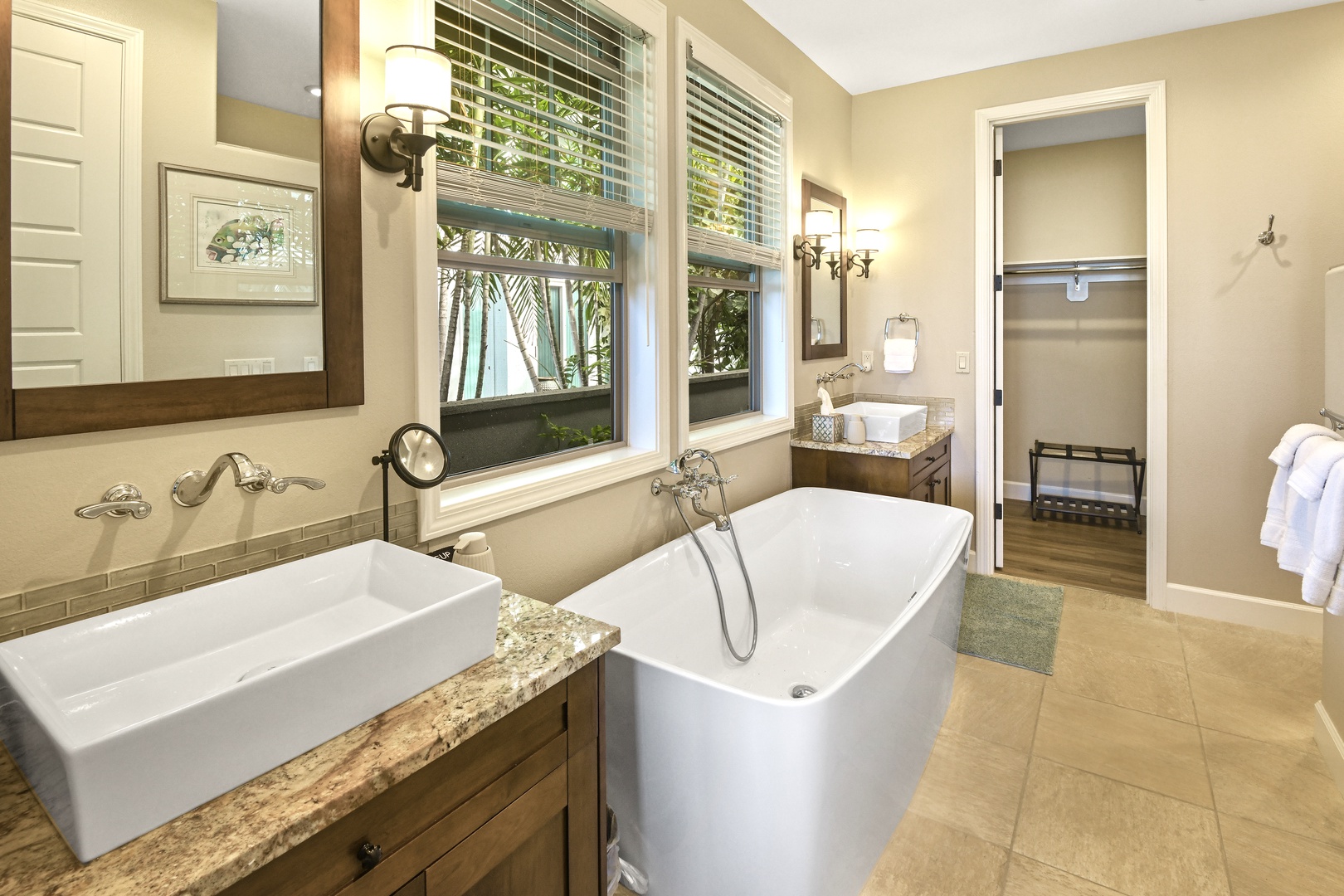 Unwind in your luxurious bathroom featuring a soaking tub and vessel sink, where natural light creates the perfect spa-like retreat.