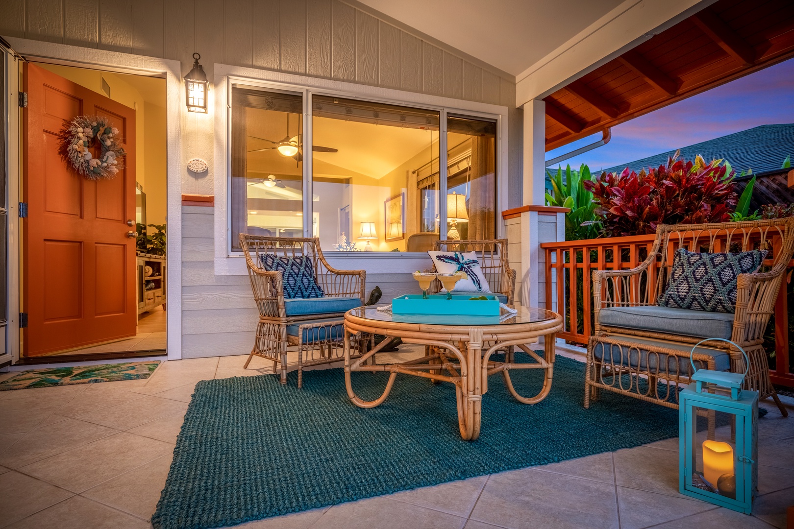 Your welcoming covered lanai awaits with cozy rattan seating and tropical accents, perfect for sipping morning coffee or unwinding as the sky turns to sunset hues.