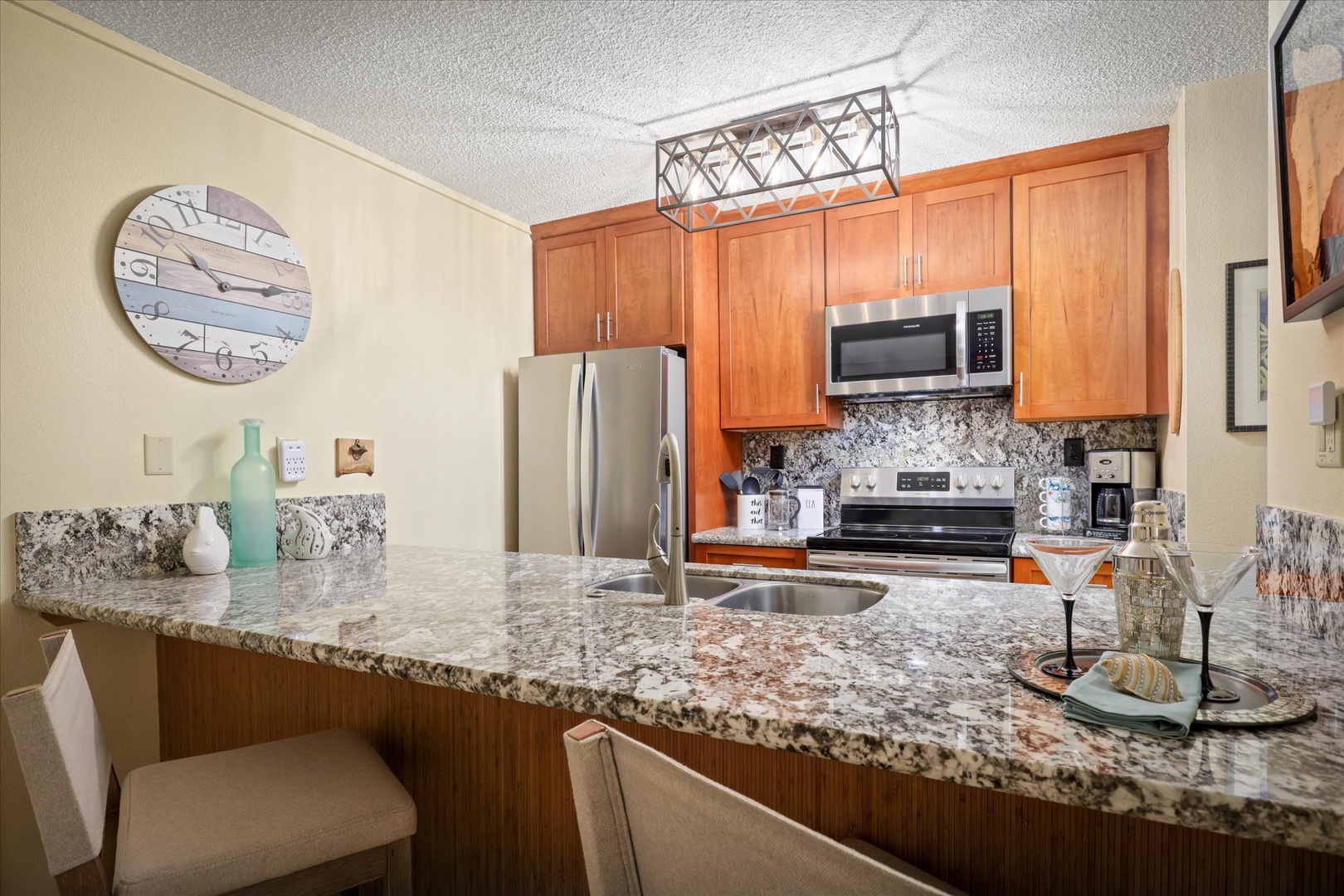 Your fully equipped kitchen features granite countertops, stainless steel appliances, and everything you need to prepare a delicious meal—all within a warm, inviting space perfect for gathering.