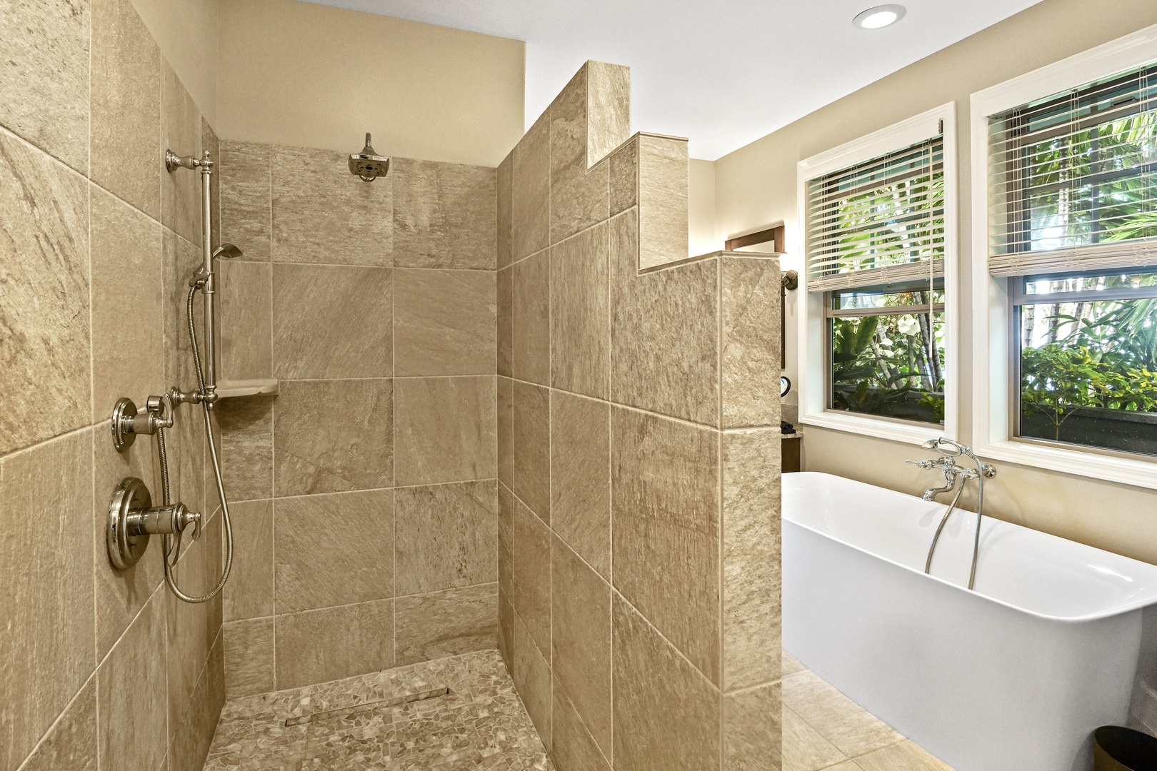 Unwind in your spa-inspired bathroom with a luxurious soaking tub and spacious walk-in shower featuring beautiful natural stone tiles.