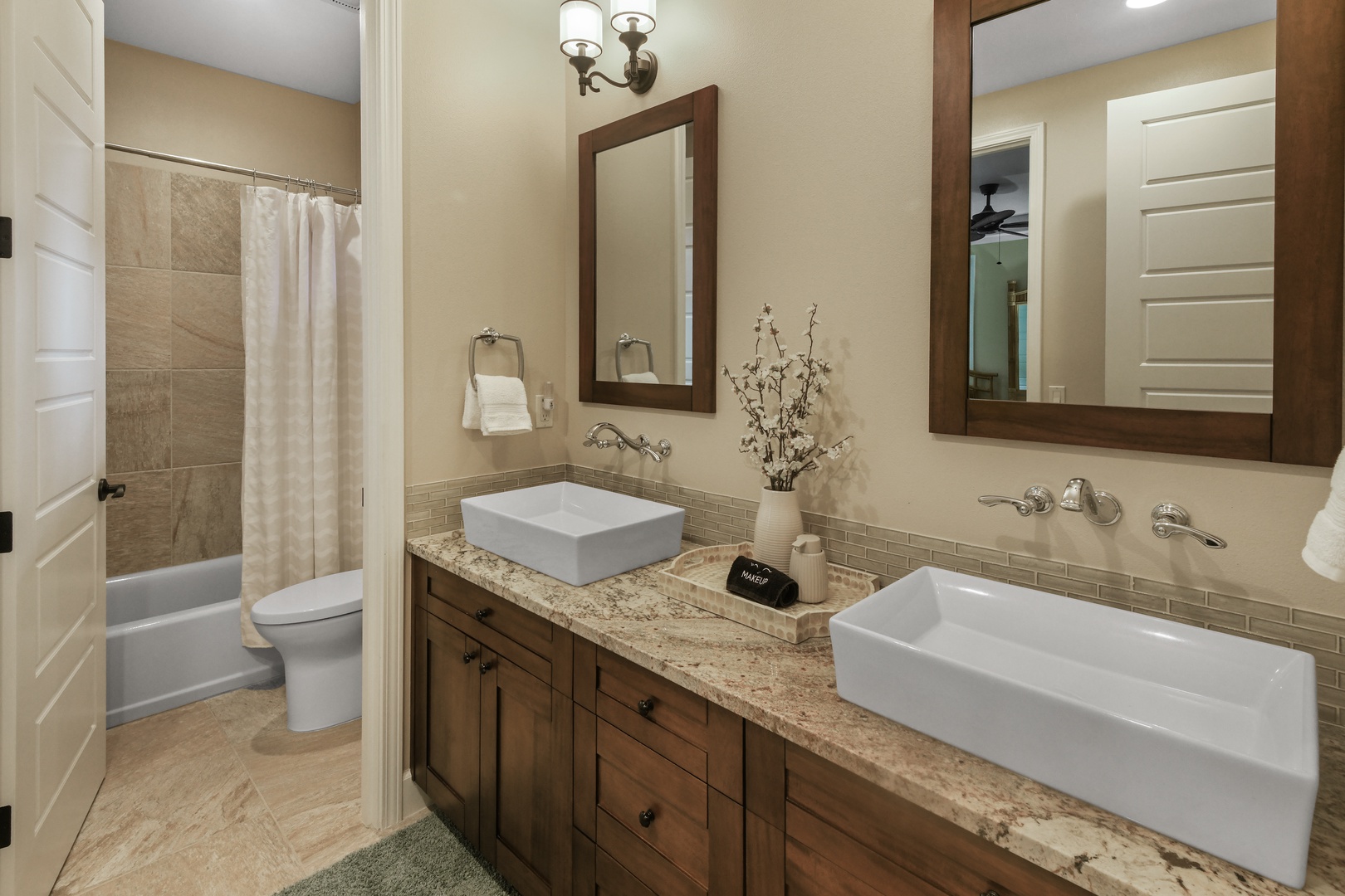 Unwind in your elegant bathroom with dual vessel sinks, granite counters, and a relaxing shower-tub combo.