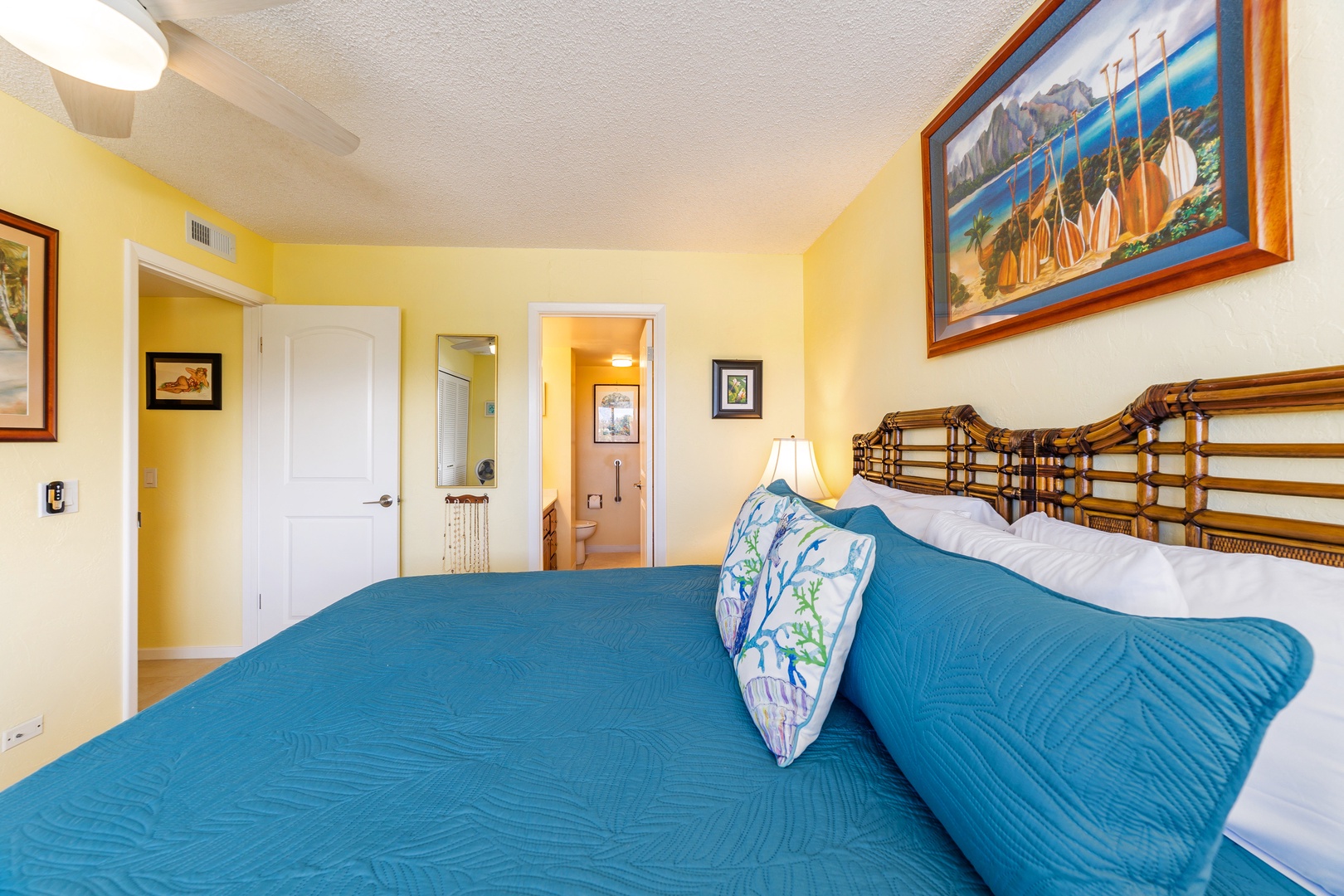 Drift off in your coastal-inspired bedroom with cheerful yellow walls and a comfy bed dressed in ocean-blue linens. Wake refreshed in your inviting retreat.