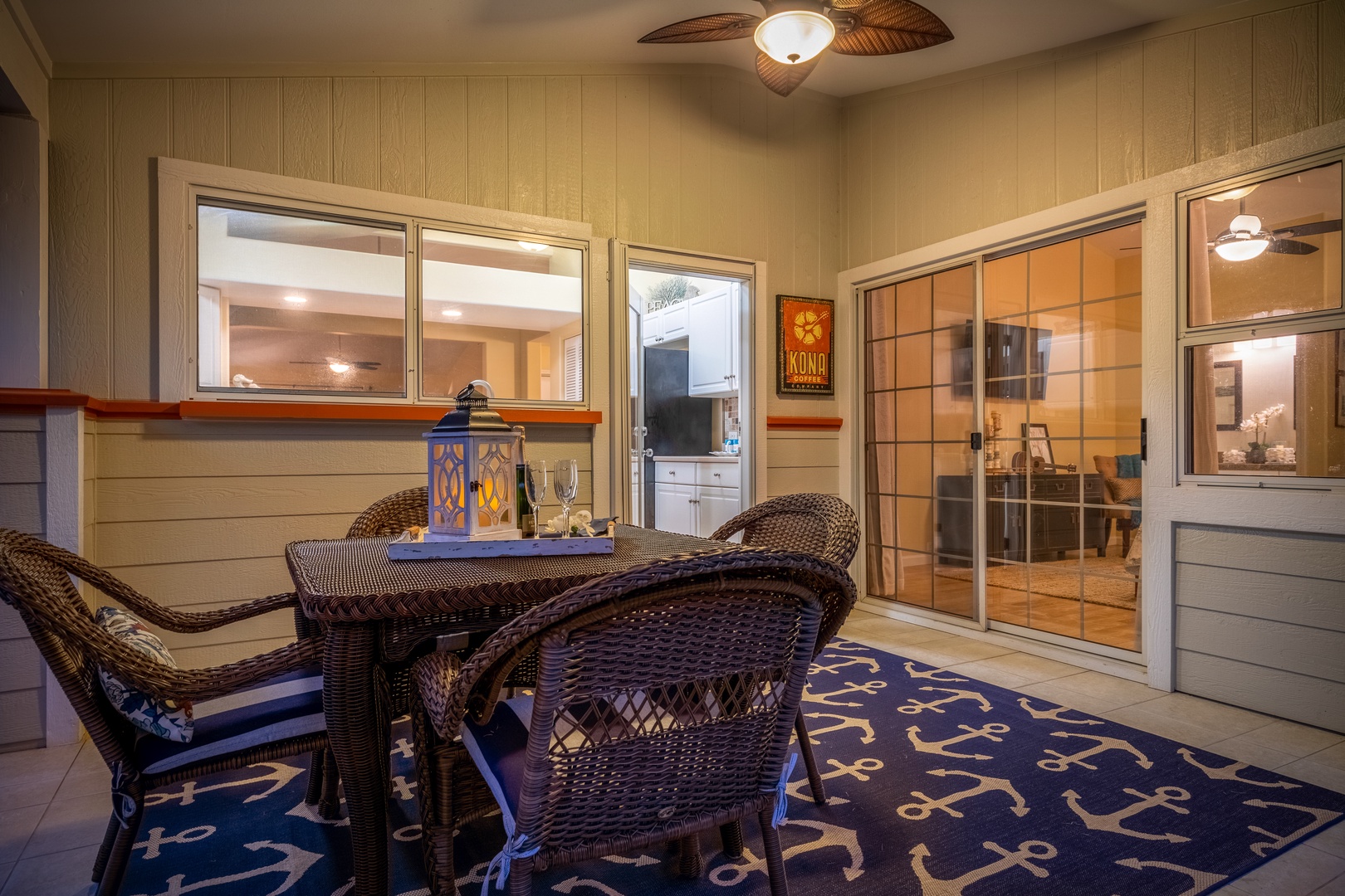 Your private lanai awaits with comfortable wicker seating, tropical ceiling fan, and easy access to the bright indoor living space—perfect for sipping coffee at sunrise or cocktails under the stars.