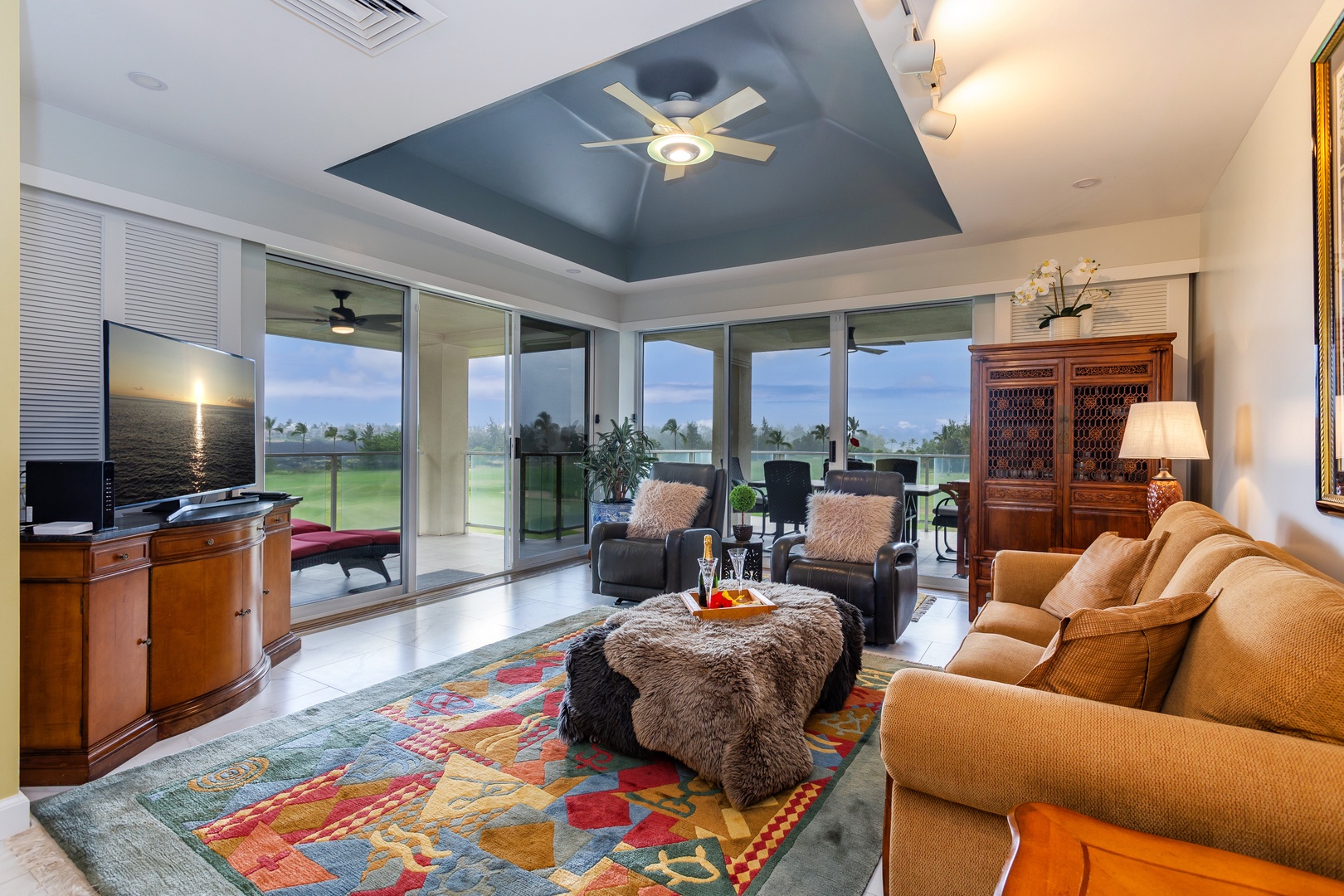 Sink into plush seating as natural light streams through floor-to-ceiling windows, framing peaceful views of lush greens and open skies beyond your comfortable retreat.